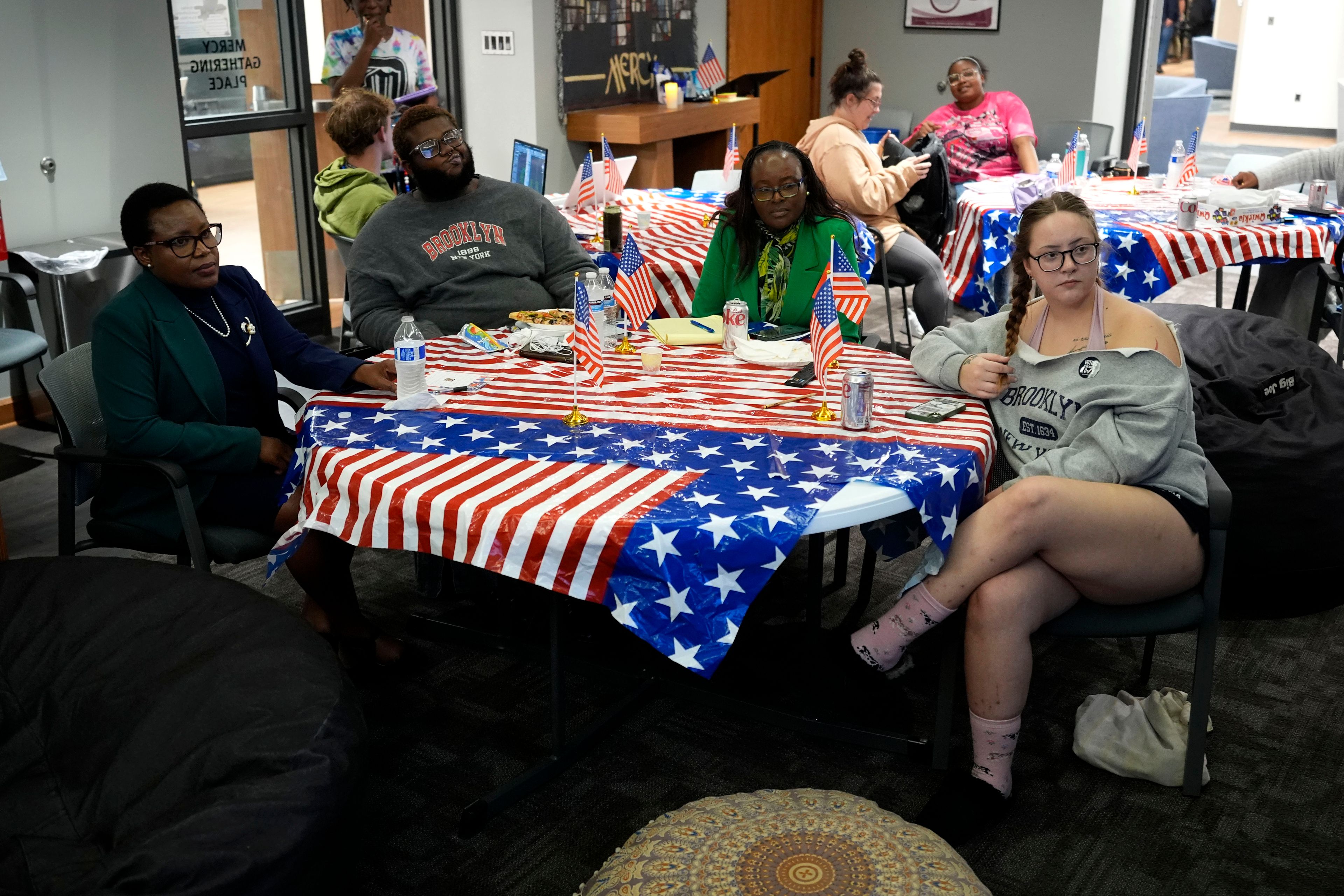 Students and staff watch early returns during an election night watch party at the University of Detroit Mercy, Tuesday, Nov. 5, 2024, in Detroit. (AP Photo/Charlie Neibergall)