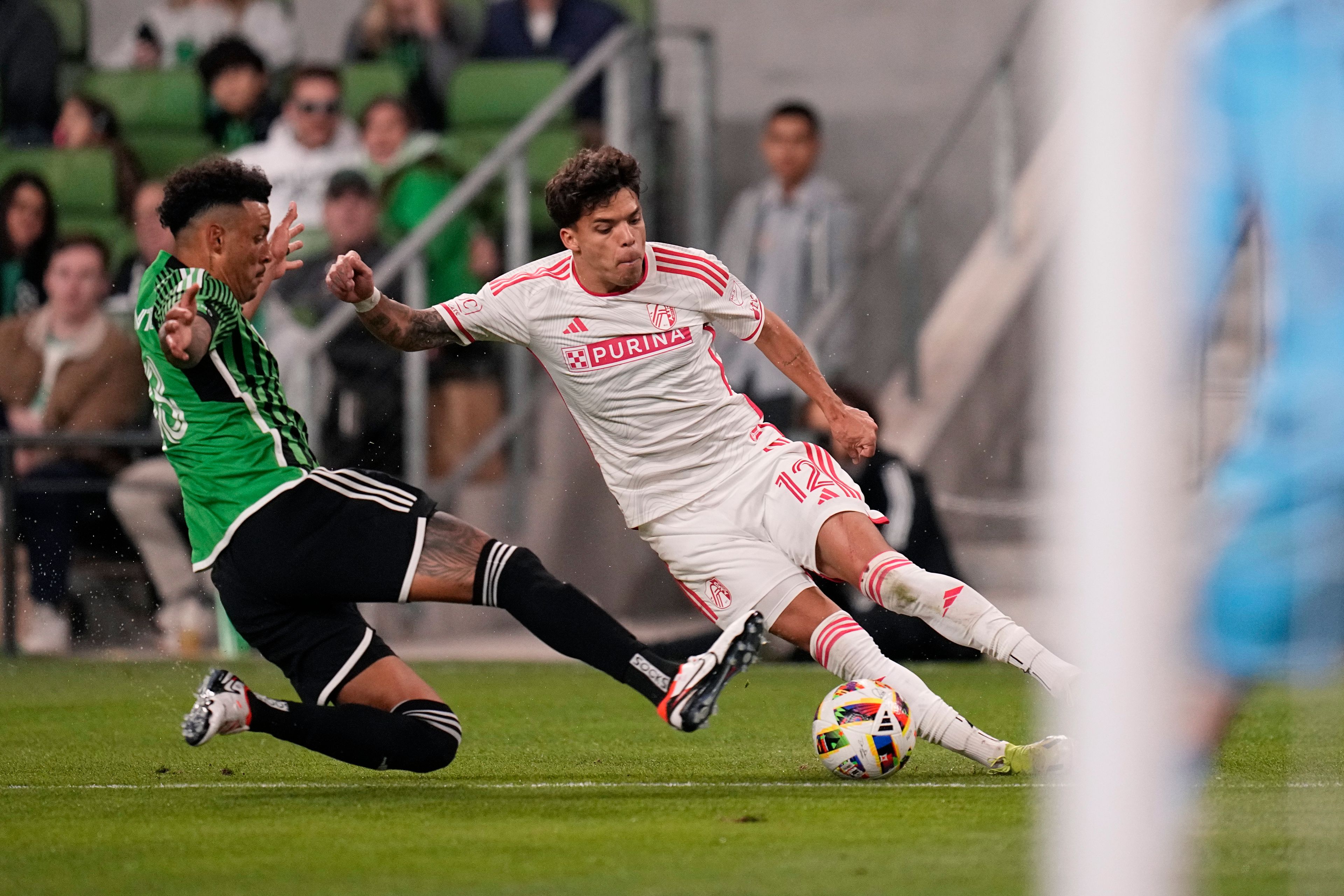 St. Louis City midfielder Célio Pompeu (12) tries to work the ball past Austin FC defender Julio Cascante during the second half of an MLS soccer match Saturday, March 9, 2024, in Austin, Texas. (AP Photo/Eric Gay)