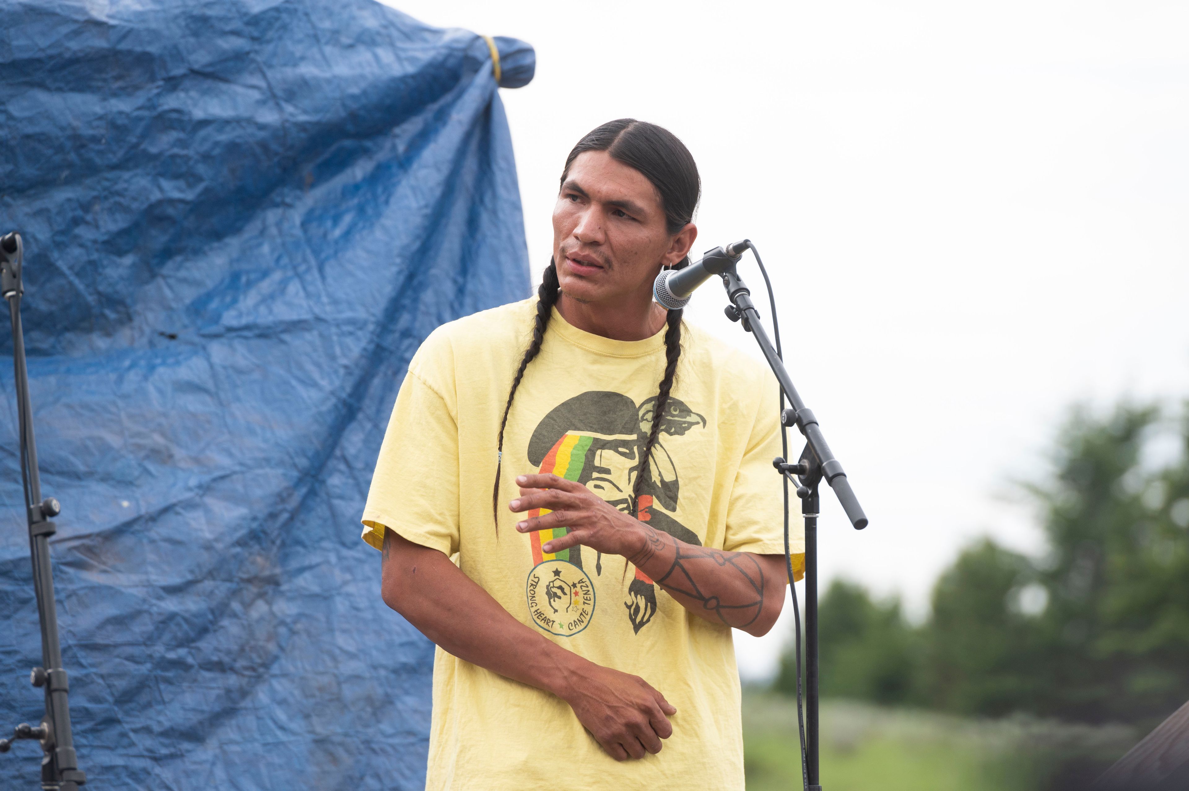 Devin Oldman, a member of the Northern Arapahoe tribe, speaks during a naming ceremony for a white buffalo calf at the headquarters of the Buffalo Field Campaign in West Yellowstone, Mont., Wednesday, June 26, 2024. The reported birth of the calf in Yellowstone National Park fulfills a Lakota prophecy that portends better times. (AP Photo/Sam Wilson)