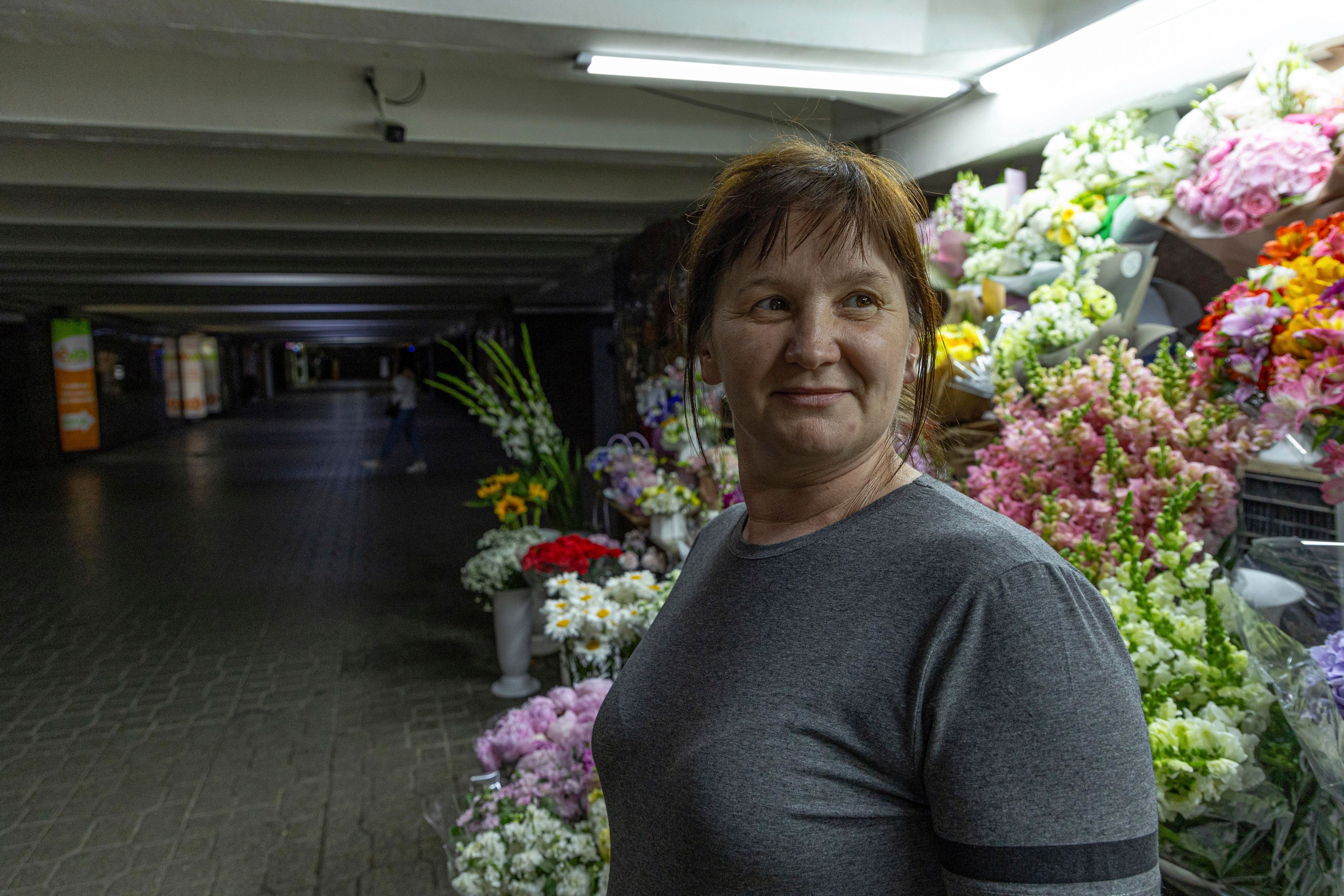 Olha Semynog stands by her flower stall in an underpass in Kyiv, Ukraine, Tuesday, June 25, 2024. Despite hardships brought by war flowers fill Kyiv and other Ukrainian cities. They burst out of planters that line the capital's backroads and grand boulevards and are fixed to lampposts. Semynog sells bunches of flowers for $2.50 all the way up to giant bouquets for $75. (AP Photo/Anton Shtuka)