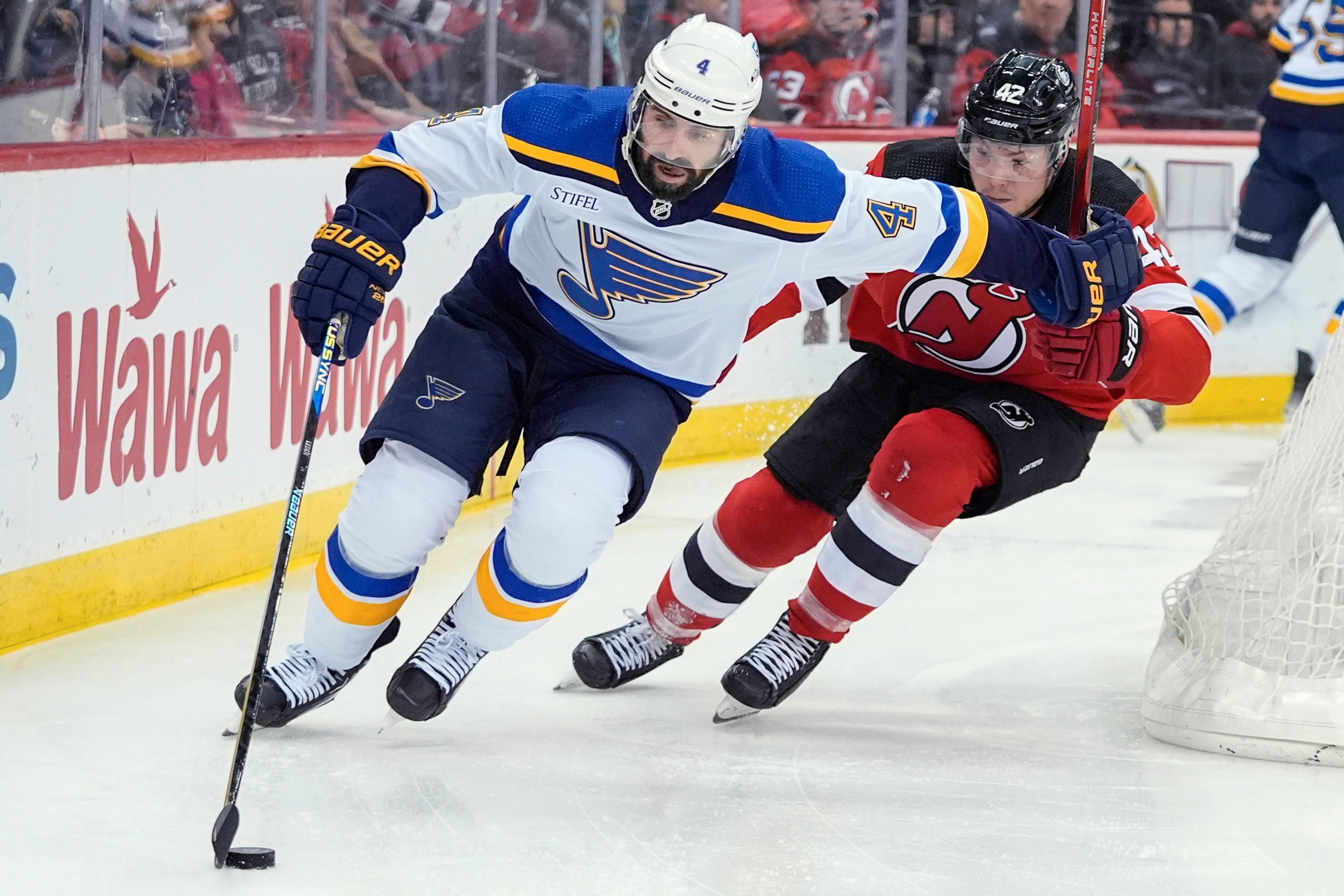 St. Louis Blues' Nick Leddy (4) drives past New Jersey Devils' Curtis Lazar (42) during the second period of an NHL hockey game Thursday, March 7, 2024, in Newark, N.J. (AP Photo/Frank Franklin II)