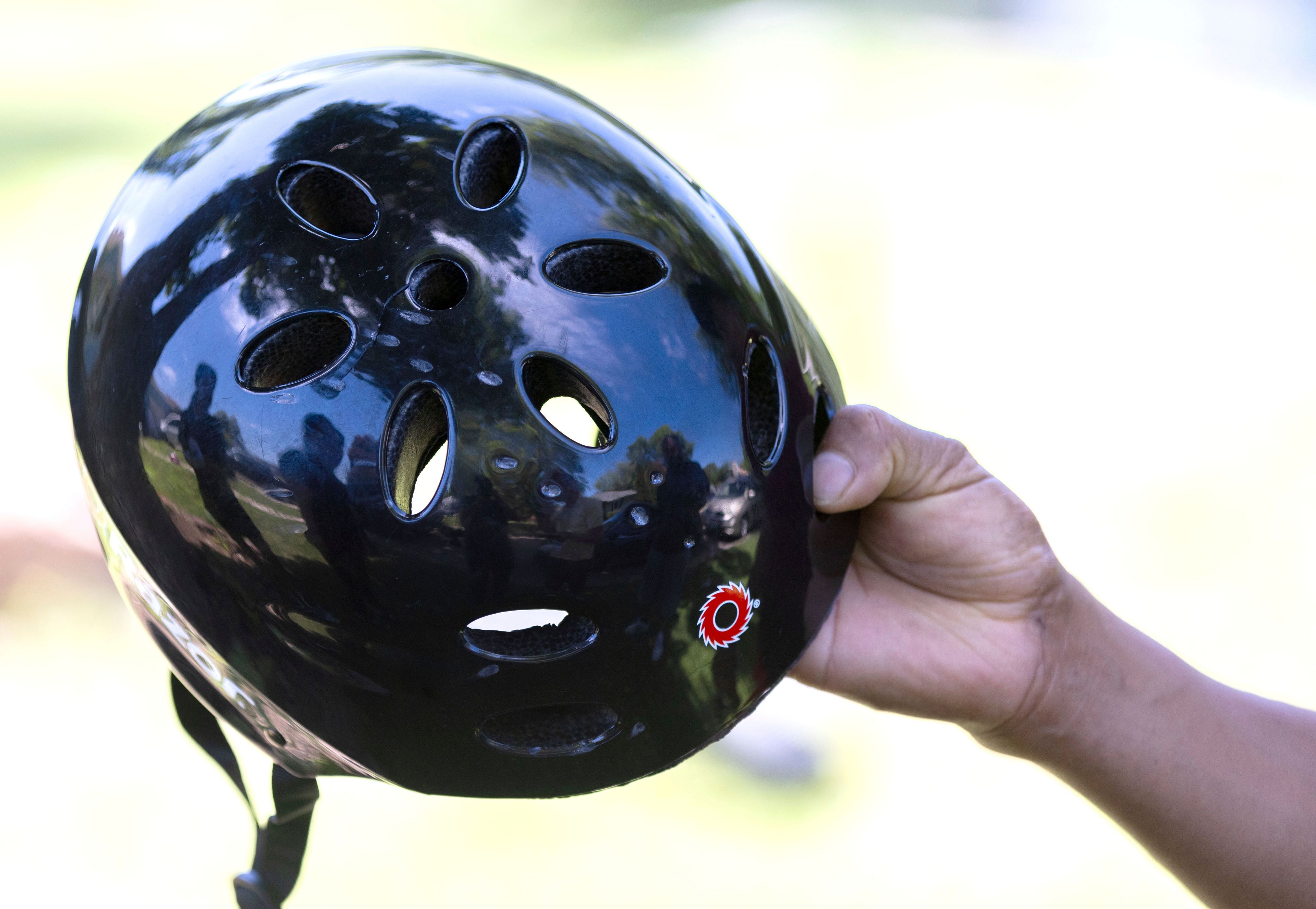 Alberto Bautista holds the helmet his three-year-old grandson was wearing when he and several other people were shot the day before in Crete, Neb. on Saturday, June 29, 2024. The helmet shows marks from the shotgun blast. (Chris Machian/Omaha World-Herald via AP)