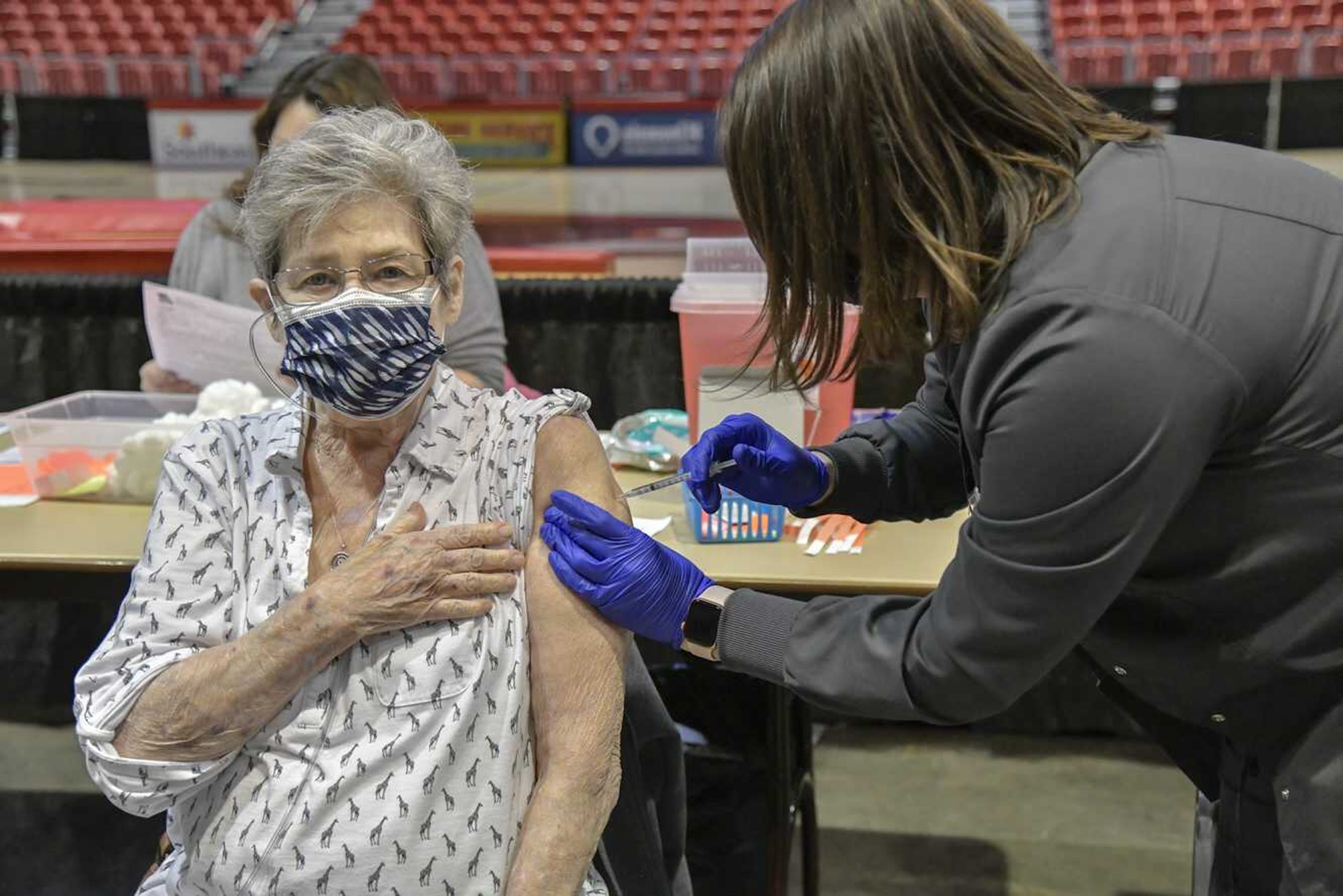 Left, Linda Crile receives her first COVID-19 vaccine dose at the Show Me Center in Cape Girardeau on Friday, Jan. 29, 2021.