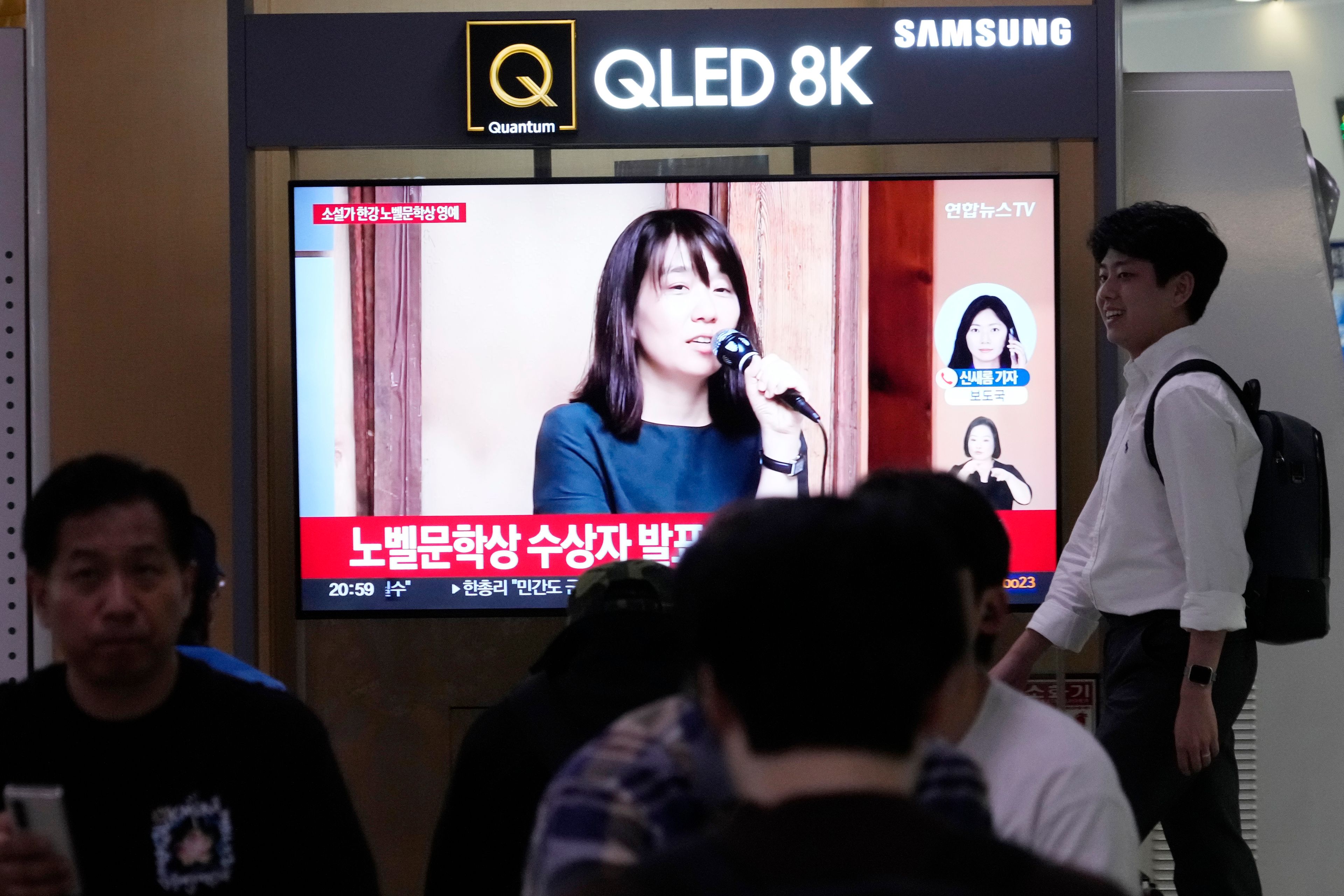 A TV screen shows a file image of the winner of the 2024 Nobel Prize in Literature, South Korean writer Han Kang, during a news program at Seoul Railway Station in Seoul, South Korea, Thursday, Oct. 10, 2024. (AP Photo/Ahn Young-joon)