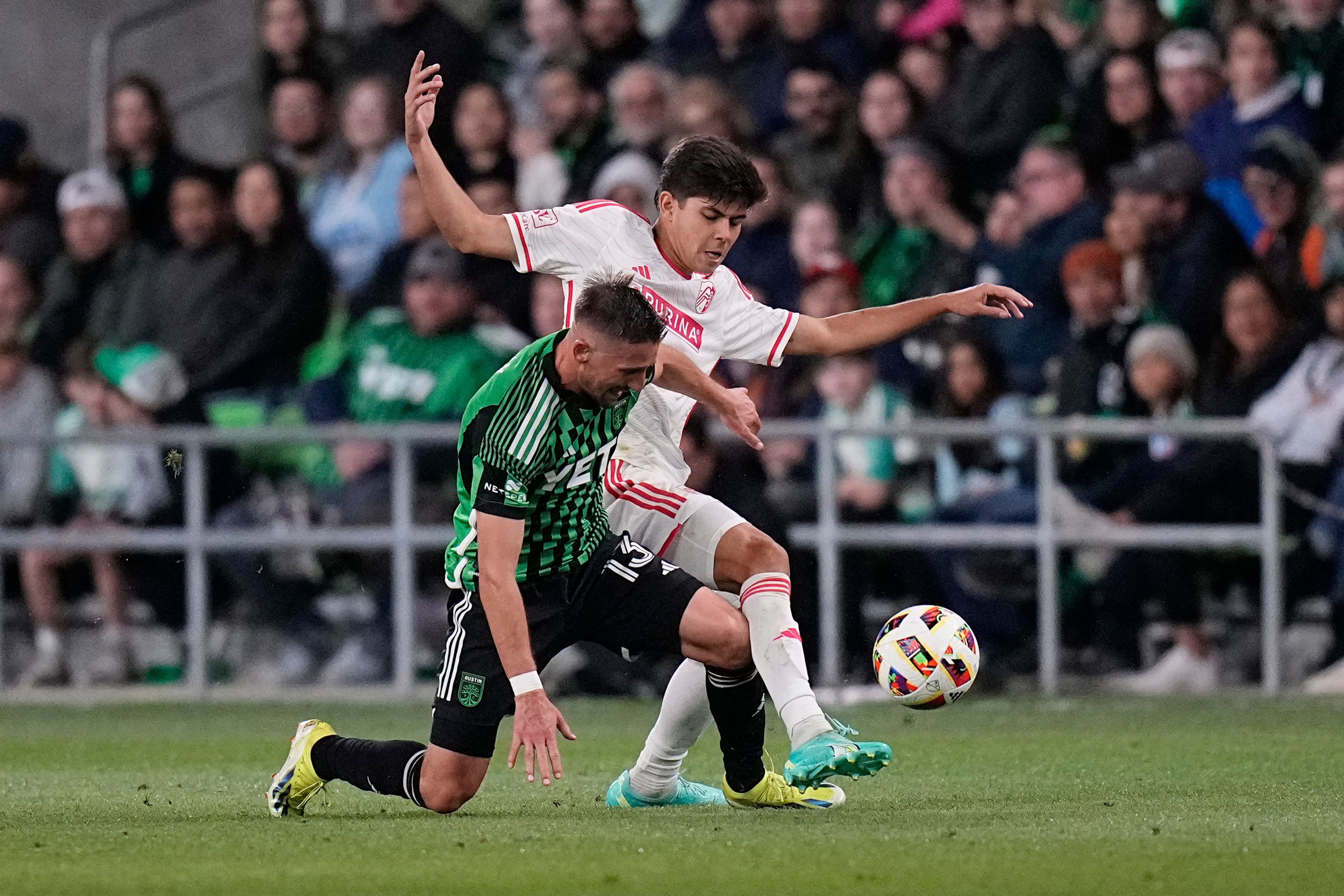 Austin FC midfielder Ethan Finlay, left, and St. Louis City defender Anthony Markanich work for control of the ball during the second half of an MLS soccer match Saturday, March 9, 2024, in Austin, Texas. (AP Photo/Eric Gay)