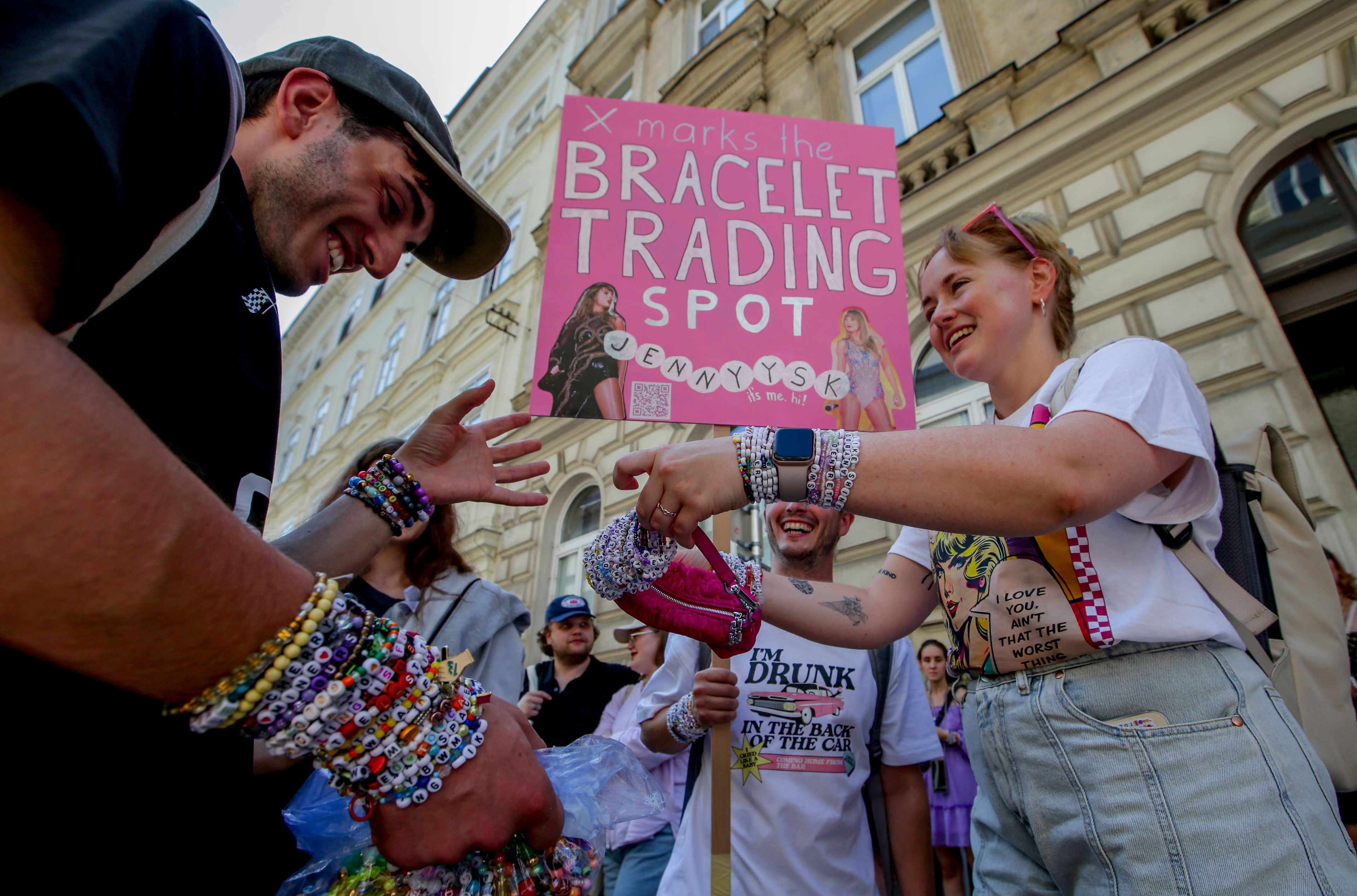 FILE - Swifties trade bracelets in the city centre in Vienna Thursday, Aug. 8, 2024, the day after organizers of three Taylor Swift concerts in the stadium in Vienna this week called them off after officials announced arrests over an apparent plot to launch an attack on an event in the Vienna area such as the concerts. (AP Photo/Heinz-Peter Bader, File)