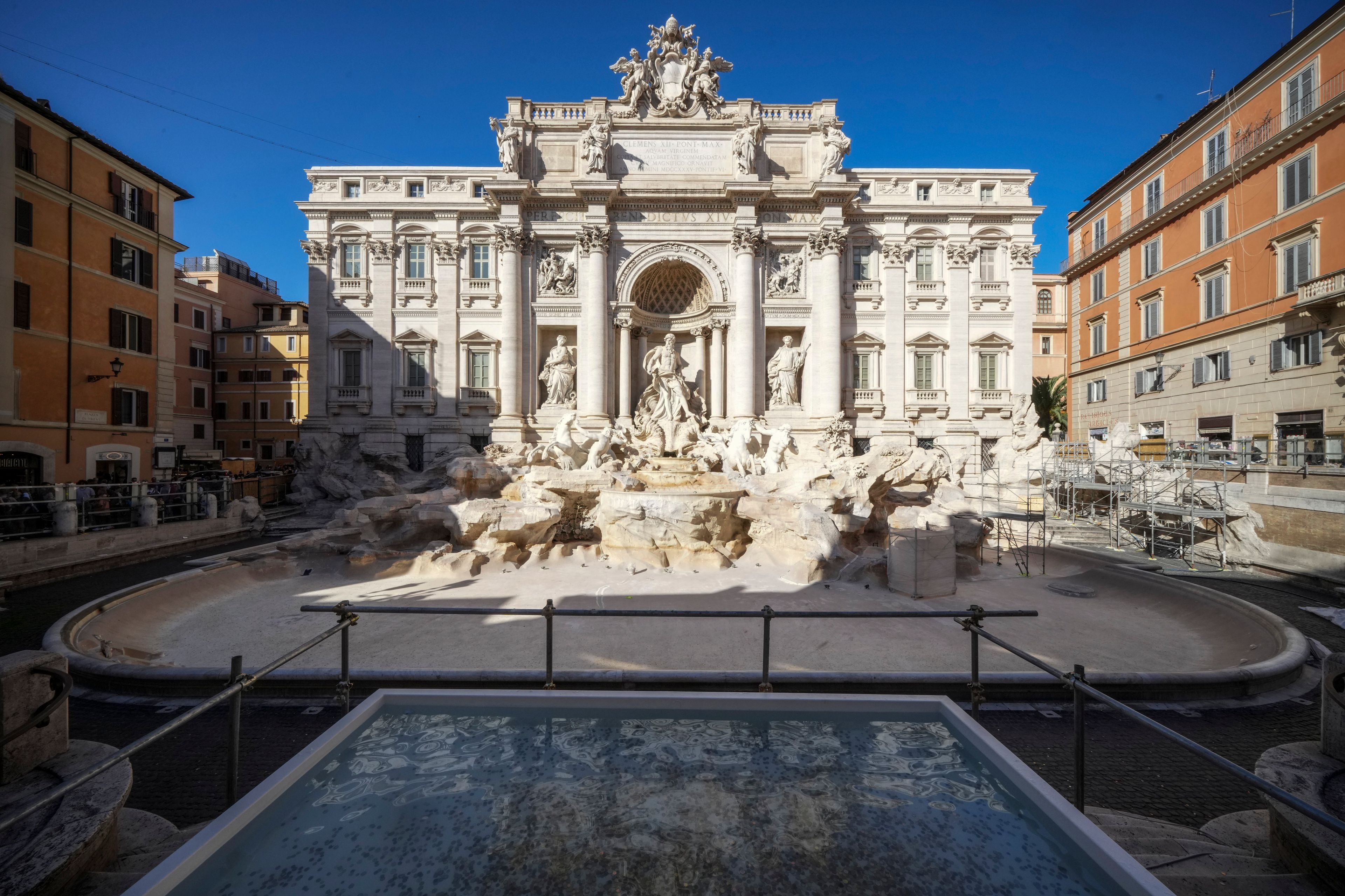 A small pool is seen in front of the Trevi Fountain to allow tourists to throw their coins in it, as the fountain has been emptied to undergo maintenance work that it is expected to be completed by the end of the year, in Rome, Friday, Nov. 1, 2024. (AP Photo/Andrew Medichini)