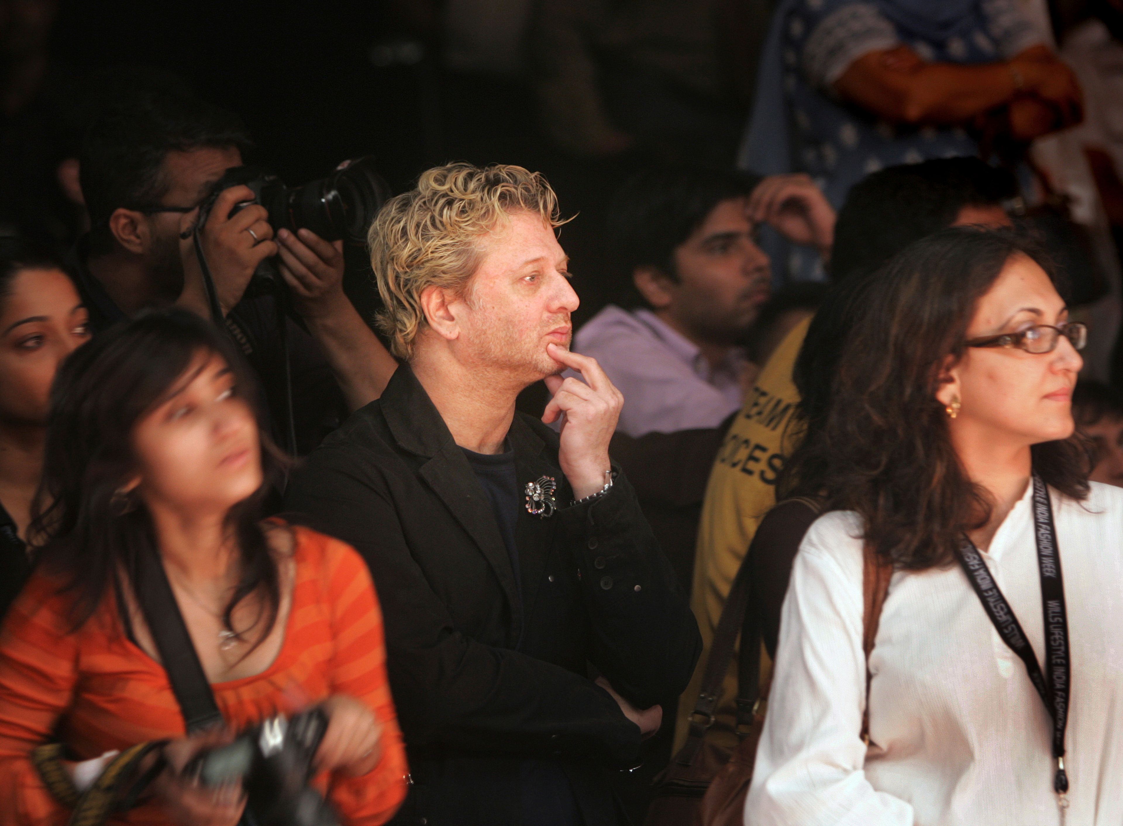 FILE - Fashion designer Rohit Bal, center, looks at a presentation by fashion designer Rajesh Pratap Singh, unseen, at the Wills Lifestyle India Fashion Week in New Delhi, India, Wednesday, Sept. 5, 2007. (AP Photo/Gurinder Osan, File)