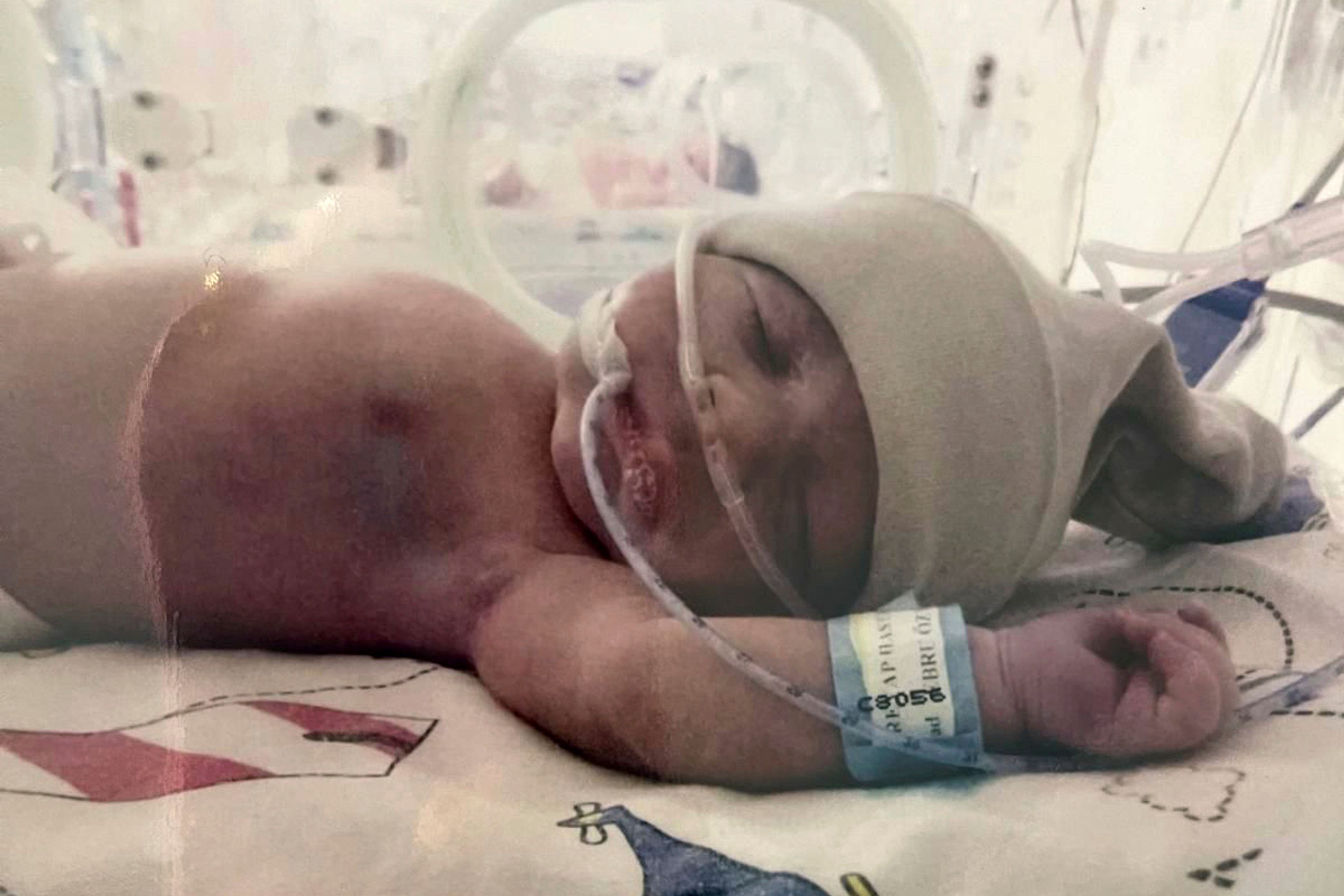 In this photo provided by the Eskici family, Eymen, the newborn son of Ozan Eskici and Ebru Eskici, lays in an incubator in the now closed Istanbul's Reyap Hospital neonatal intensive care unit in April 2019. (Eskici family via AP)