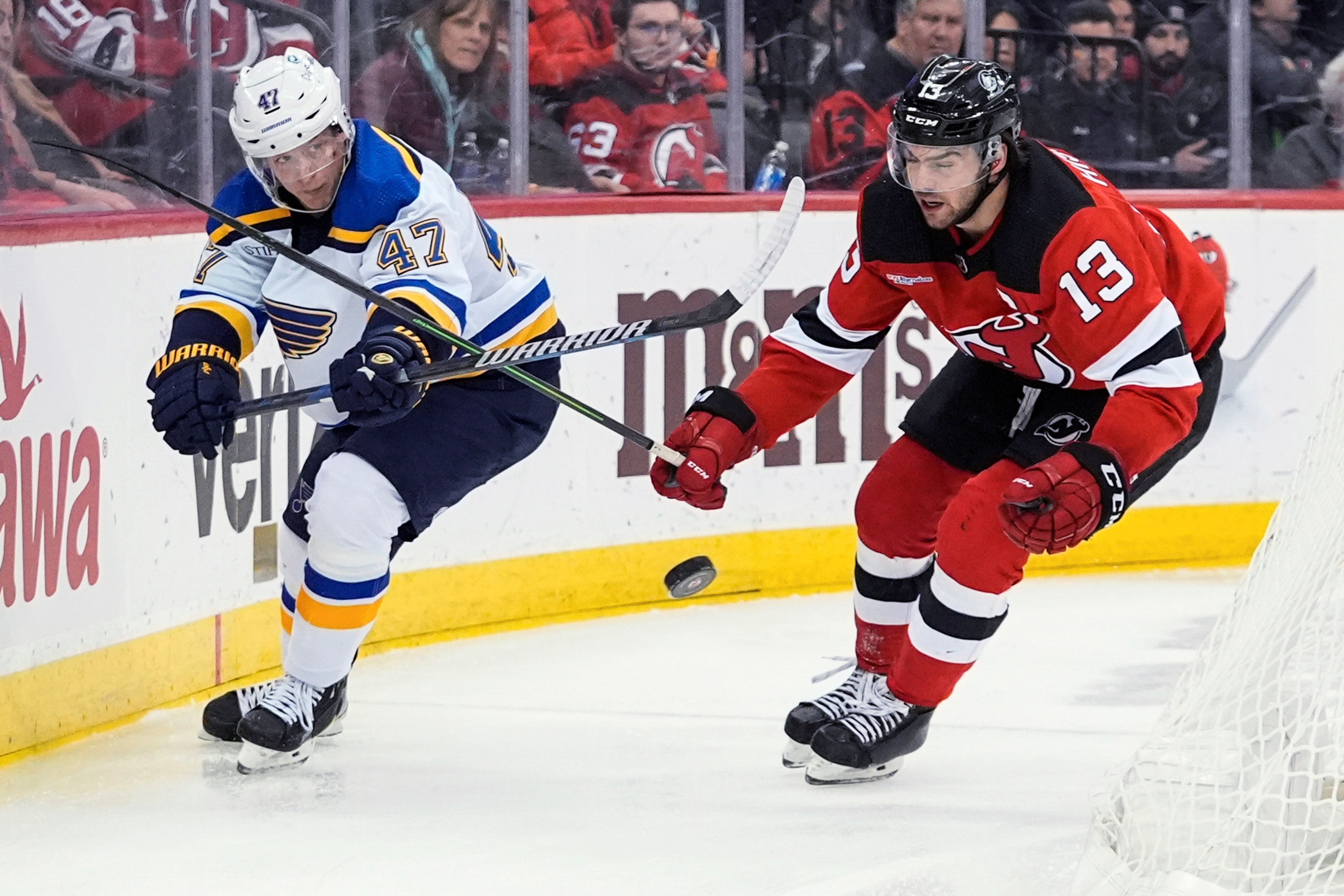 St. Louis Blues' Torey Krug (47) passes the puck away from New Jersey Devils' Nico Hischier (13) during the second period of an NHL hockey game Thursday, March 7, 2024, in Newark, N.J. (AP Photo/Frank Franklin II)