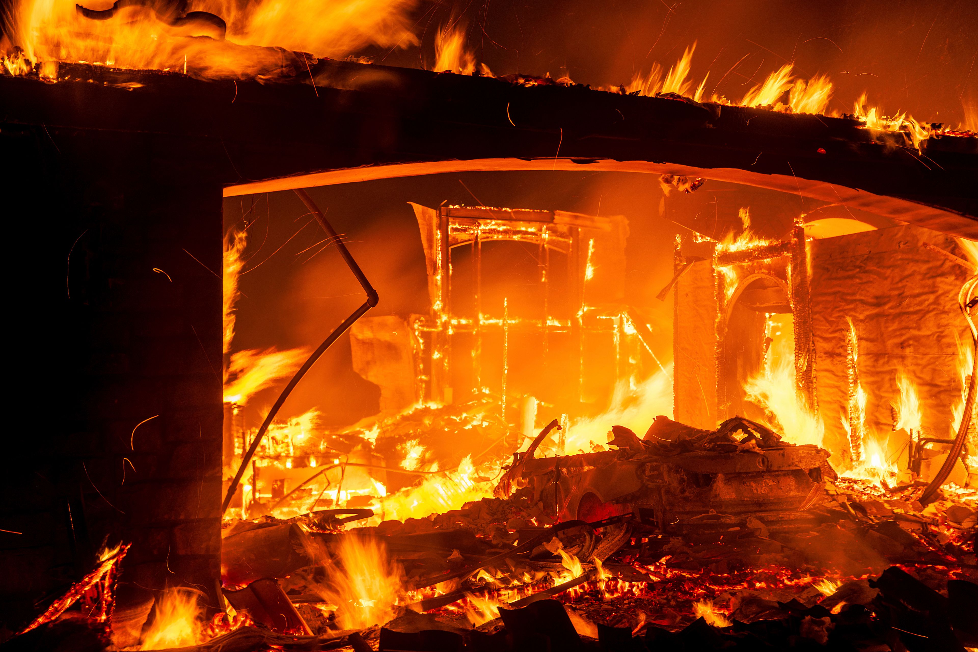 Flames consume a home as the Mountain Fire burns in Camarillo, Calif., on Wednesday, Nov. 6, 2024. (AP Photo/Noah Berger)