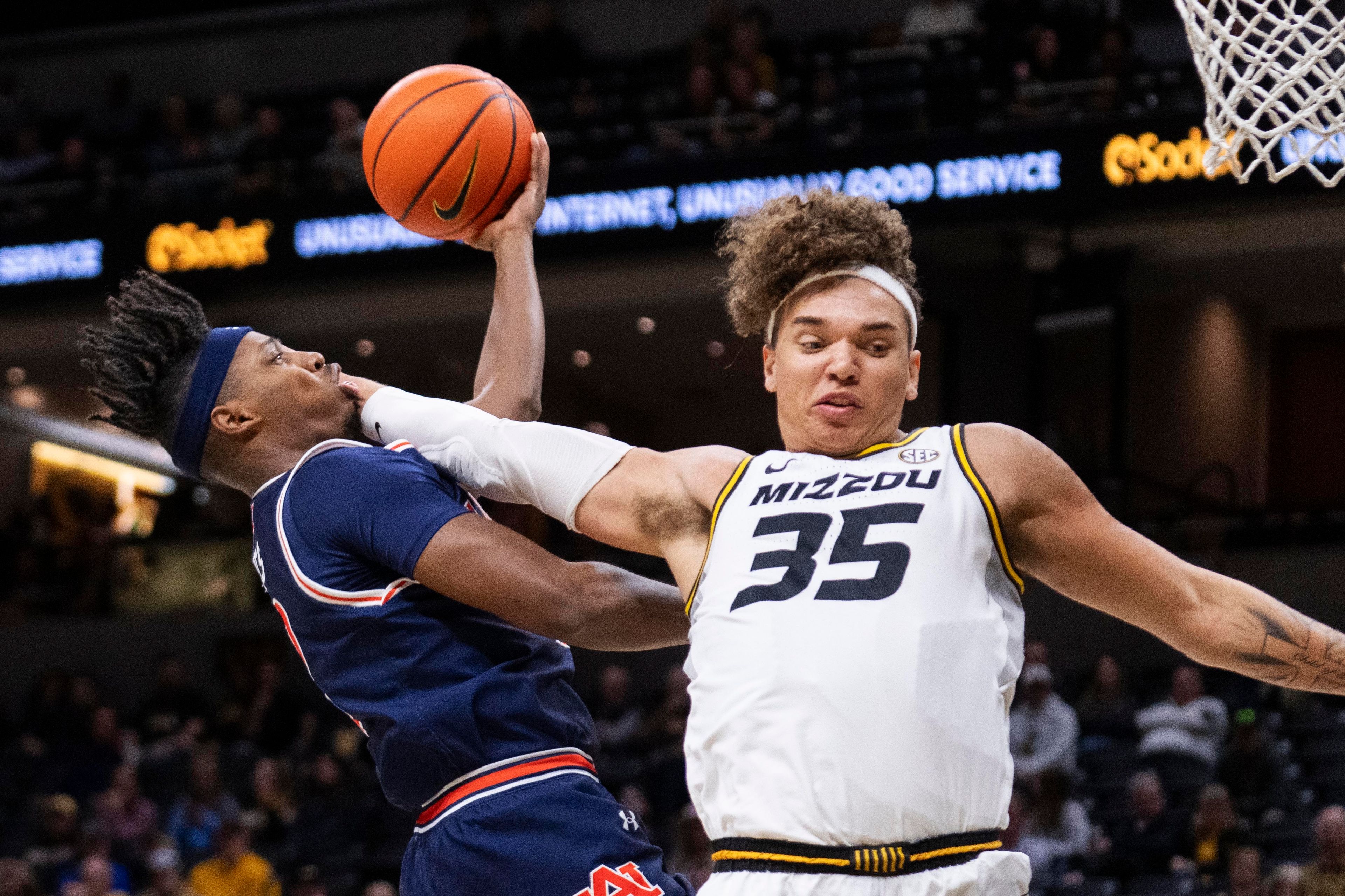 Auburn's Denver Jones, left, is fouled by Missouri's Noah Carter during the first half of an NCAA college basketball game Tuesday, March 5, 2024, in Columbia, Mo. (AP Photo/L.G. Patterson)
