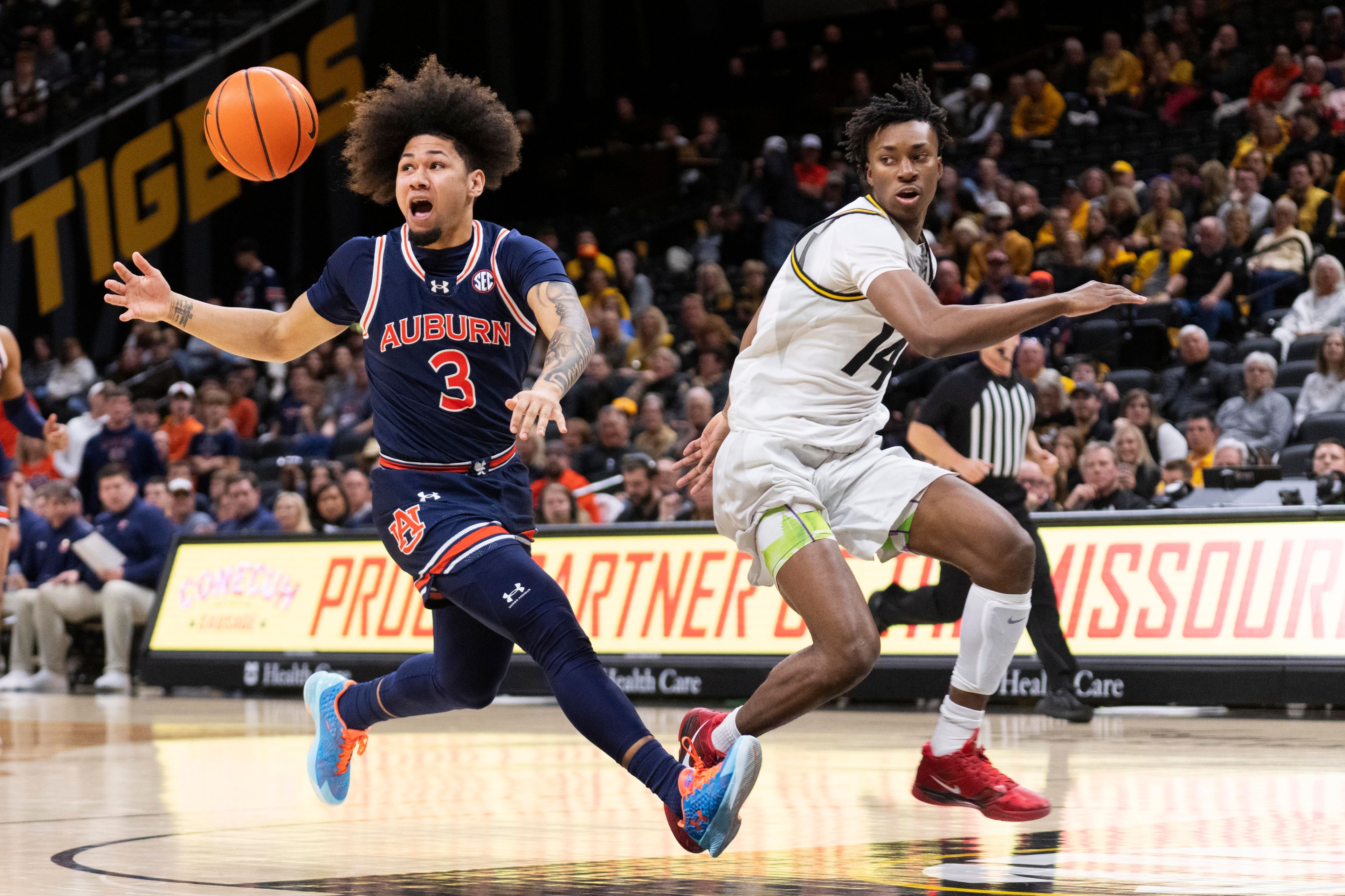 Auburn's Tre Donaldson, left, loses the ball in front of Missouri's Anthony Robinson II during the first half of an NCAA college basketball game Tuesday, March 5, 2024, in Columbia, Mo. (AP Photo/L.G. Patterson)