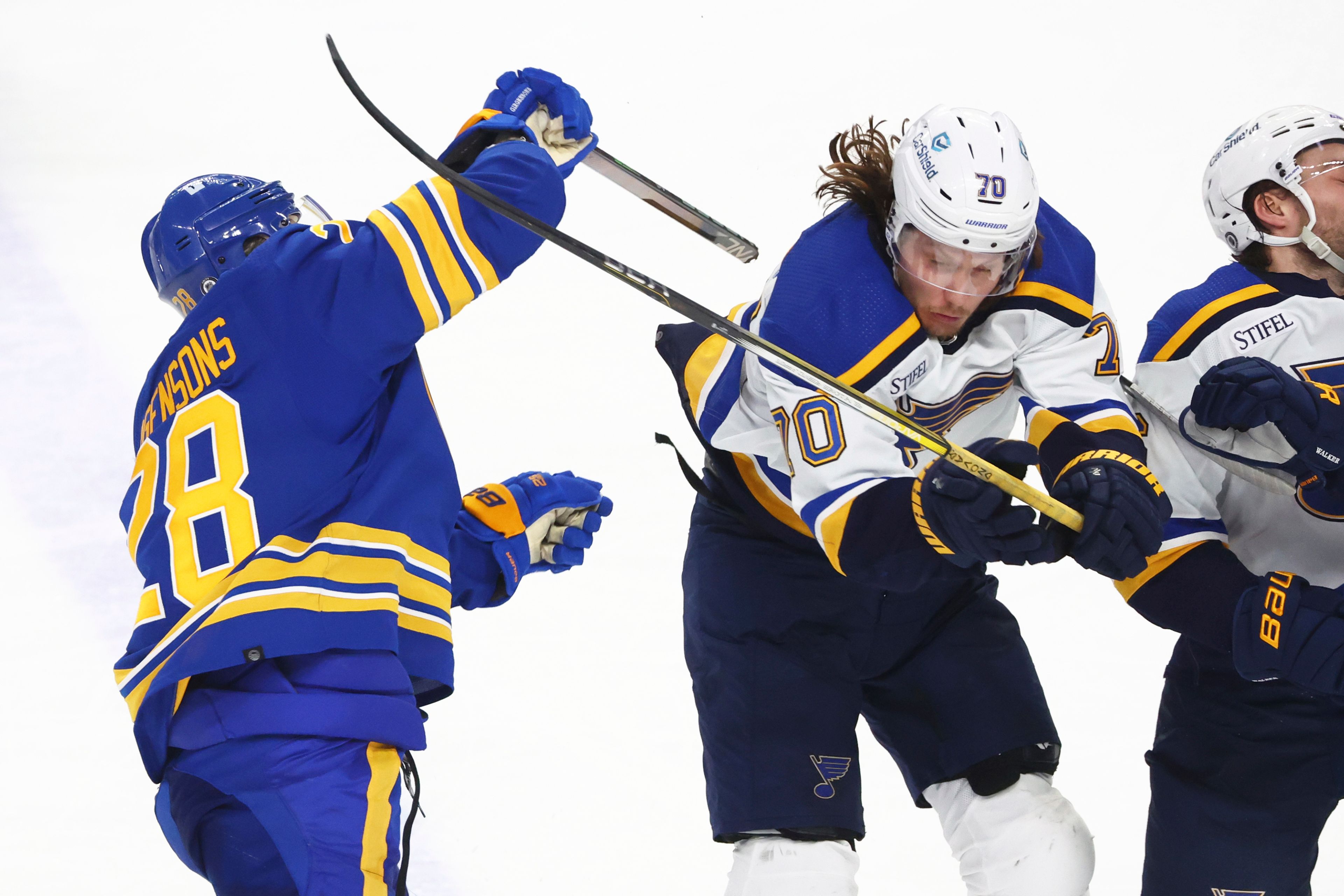 Buffalo Sabres left wing Zemgus Girgensons (28) and St. Louis Blues center Oskar Sundqvist (70) crash into each other during the third period of an NHL hockey game Saturday, Feb. 10, 2024, in Buffalo, N.Y. (AP Photo/Jeffrey T. Barnes)