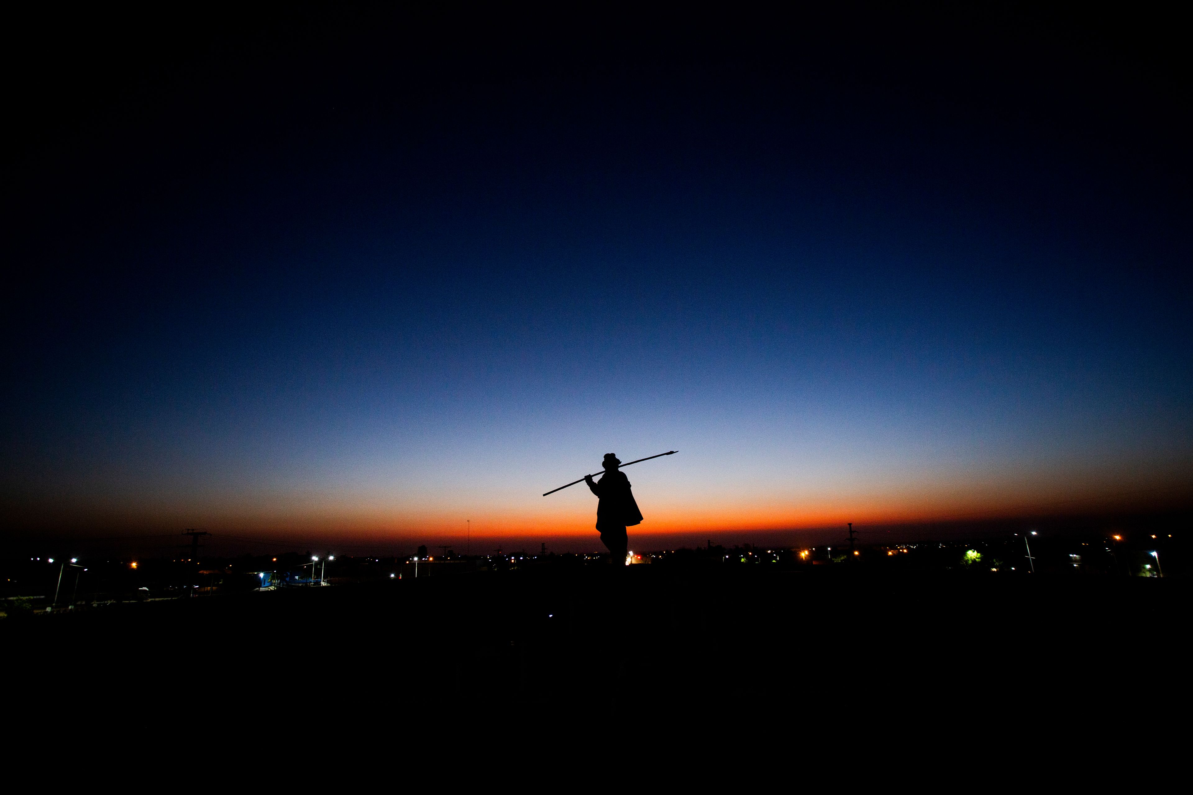 A monument to strongman Ángel Vicente “Chacho” Peñaloza, famed for defending La Rioja and other provinces in a historic 19th-century battle against national authorities, is silhouetted in La Rioja, Argentina, at dawn Friday, Sept. 13, 2024. In response to slashed federal budgets to provinces, La Rioja is printing a new emergency tender called "chachos" to pay state workers and spur the economy. (AP Photo/Natalia Diaz)