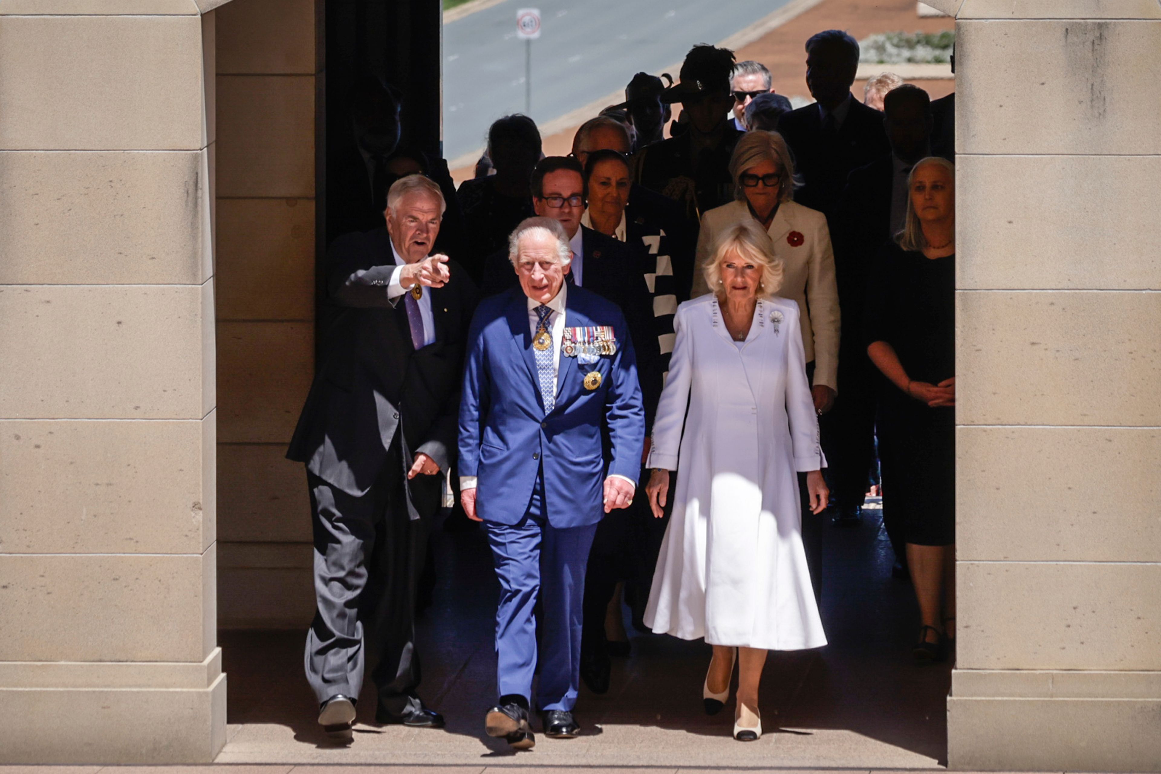 King Charles III and Queen Camilla arrive at the Australian War Memorial accompanied by Australian War Memorial Council Chair Kim Beazley, left, in Canberra, Australia, Monday, Oct. 21, 2024. (Brook Mitchell/Pool Photo via AP)