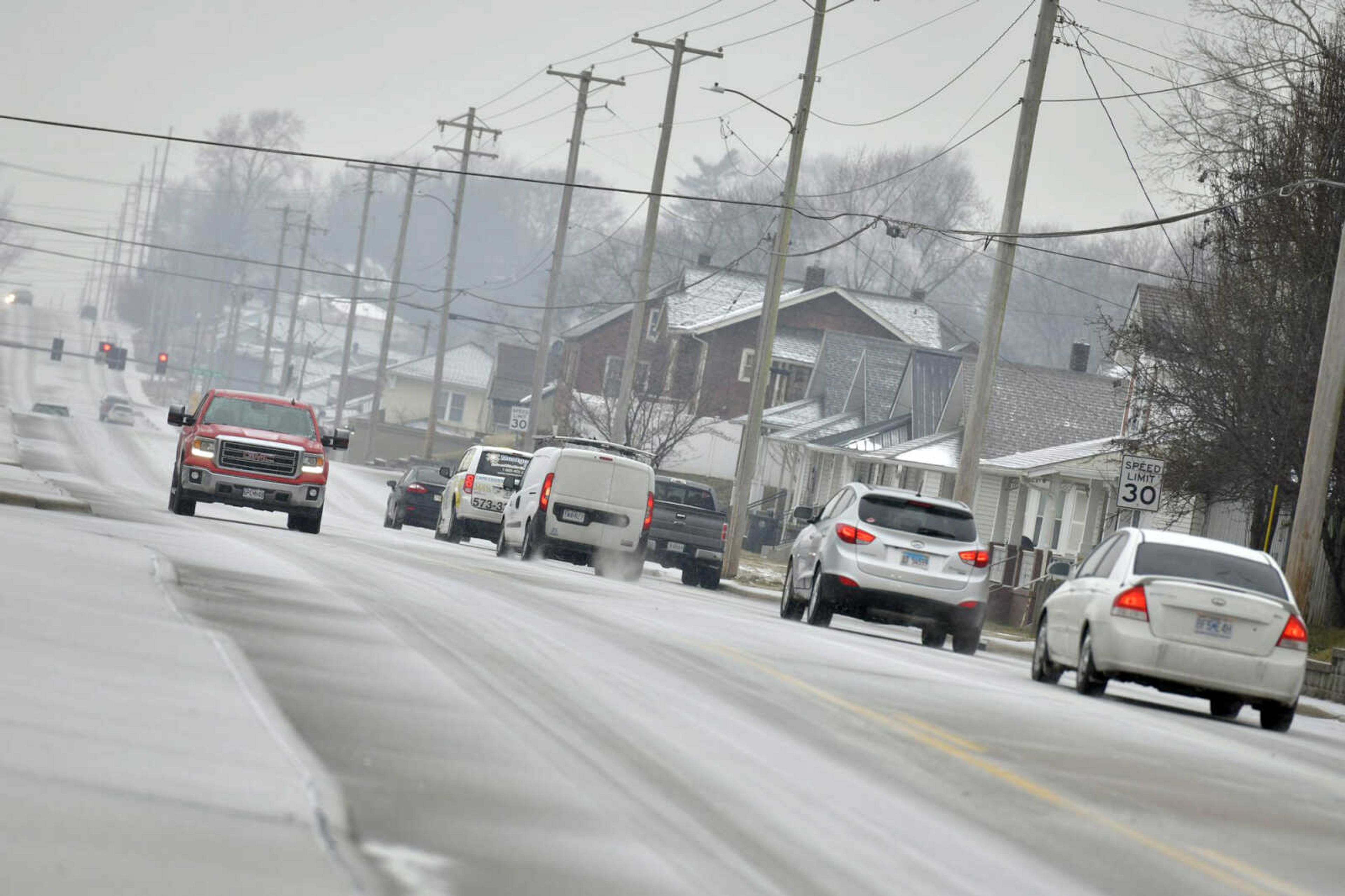 Cars drive along Independence Street after some ice accumulation Wednesday in Cape Girardeau.