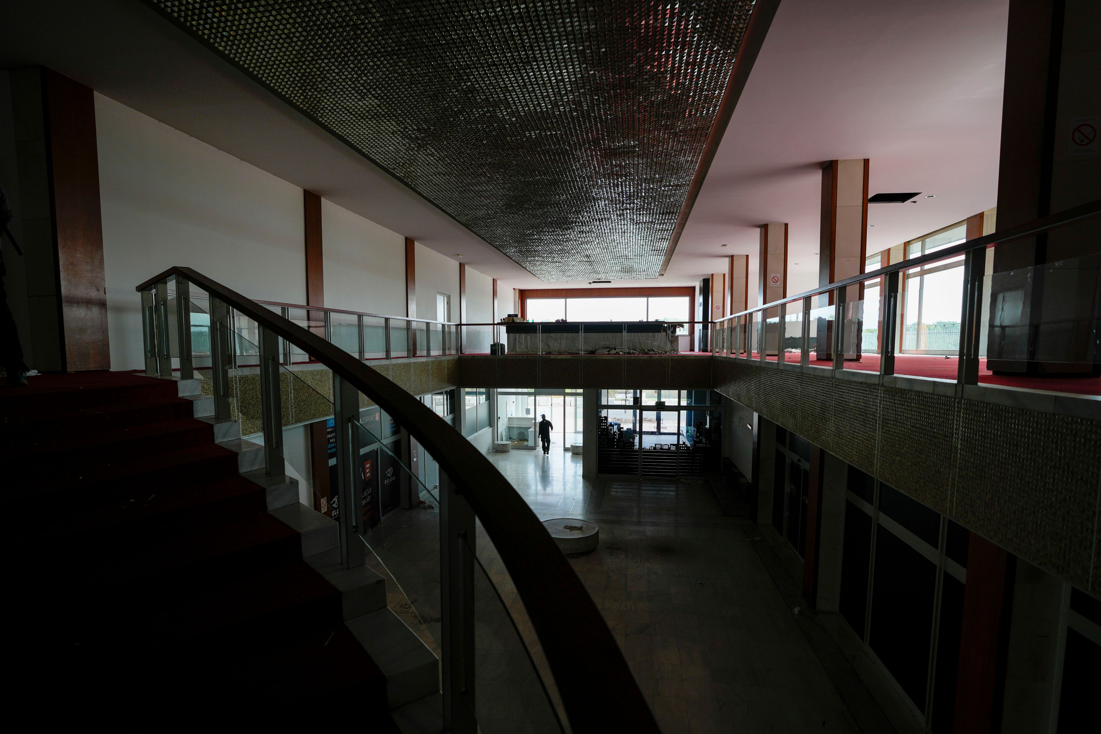 A security worker walks through Hotel Yugoslavia, once a symbol of progress in the former socialist state of Yugoslavia that broke apart in the 1990s and a favorite gathering place for local residents as well as world leaders, in Belgrade, Serbia, Thursday, Oct. 3, 2024. (AP Photo/Darko Vojinovic)