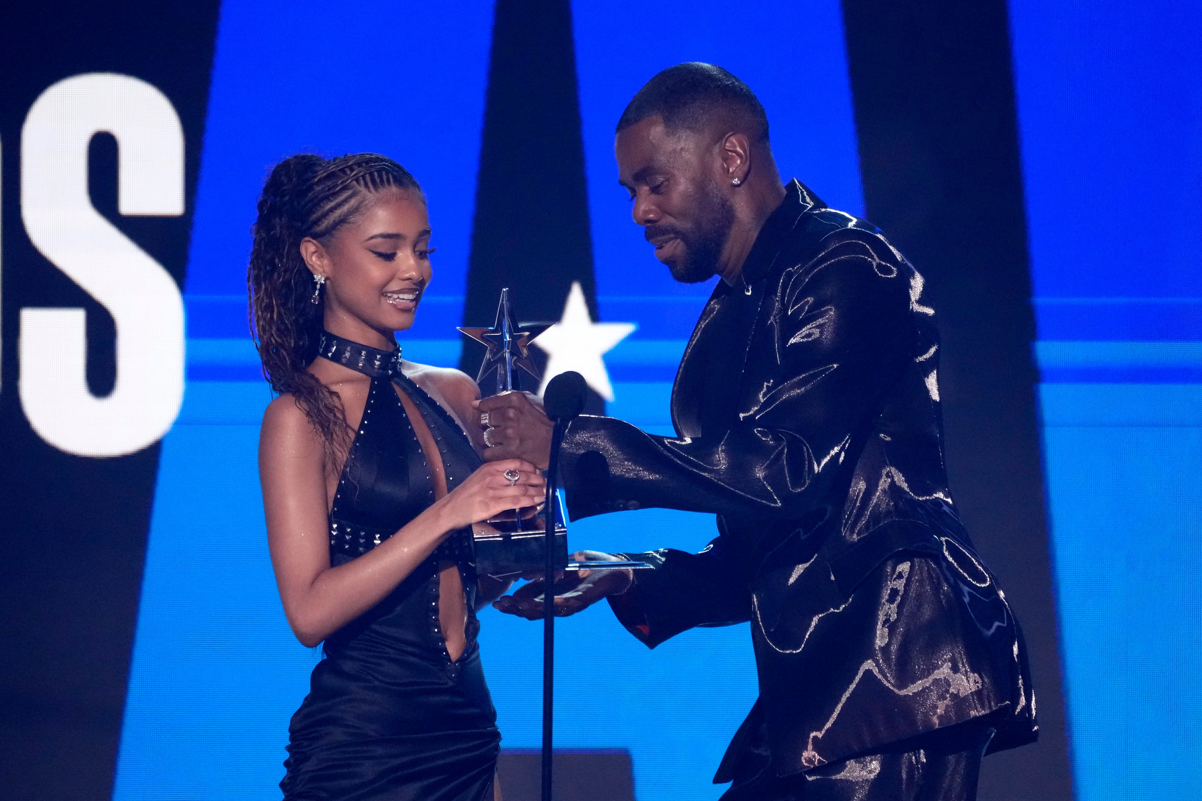 Tyla, left, accepts the award for best international act from Colman Domingo during the BET Awards on Sunday, June 30, 2024, at the Peacock Theater in Los Angeles. (AP Photo/Chris Pizzello)