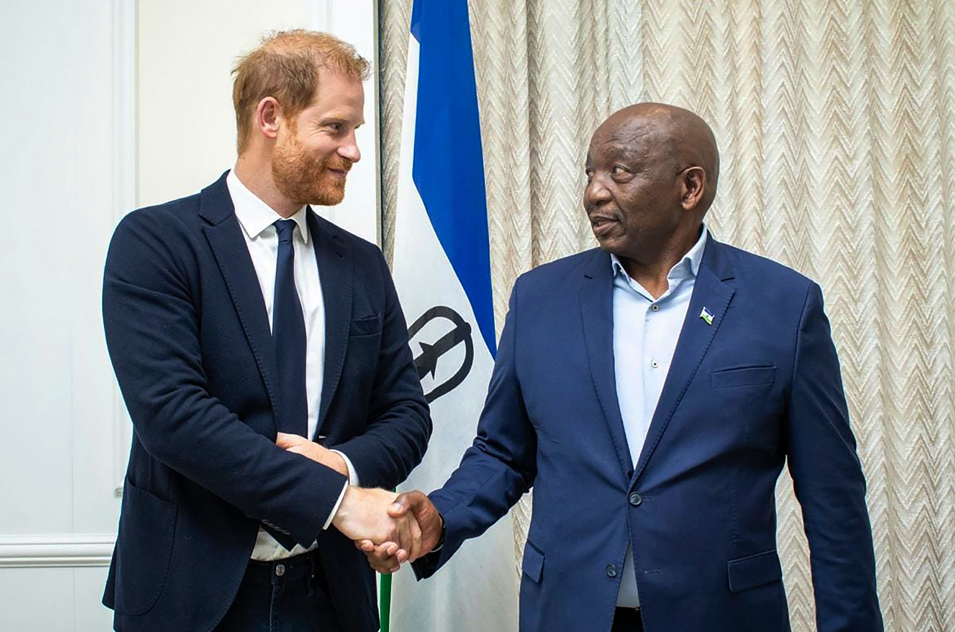 In this photo supplied by the Lesotho Government, Britain's Prince Harry, left, shakes hands with Lesotho's Prime Minister Sam Matekane, on Wednesday, Oct. 2, 2024 while visiting the tiny mountain kingdom where he co-founded a youth-focused charity in 2006 in honour of his late mother, Princess Diana. (Lesotho Government via AP)