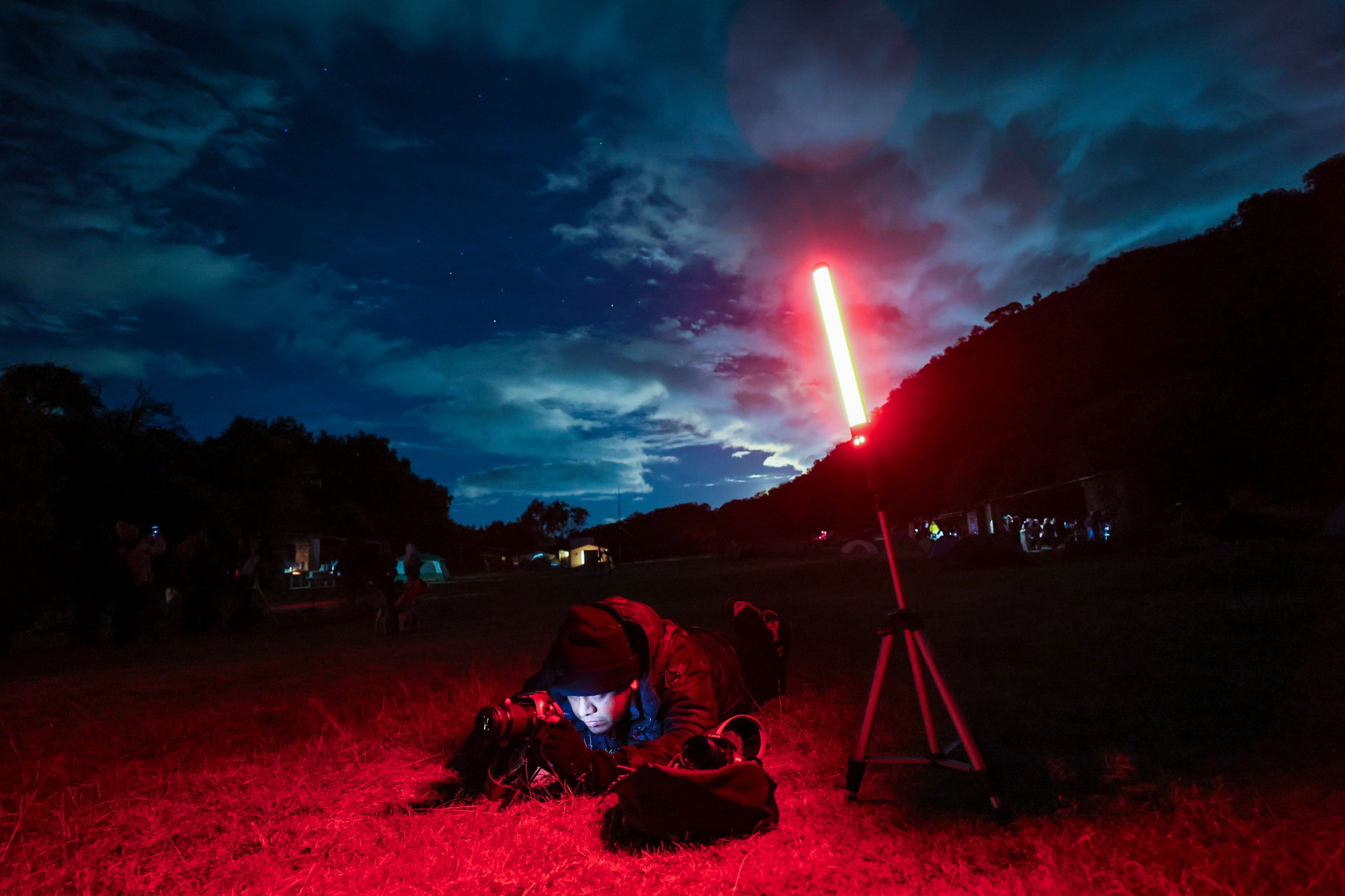 Photographer David Garcia adjusts his camera as he attends a stargazing and comet-watching gathering at Joya-La Barreta ecological park in Queretaro, Mexico, Saturday, Oct. 19, 2024. (AP Photo/Ginnette Riquelme)