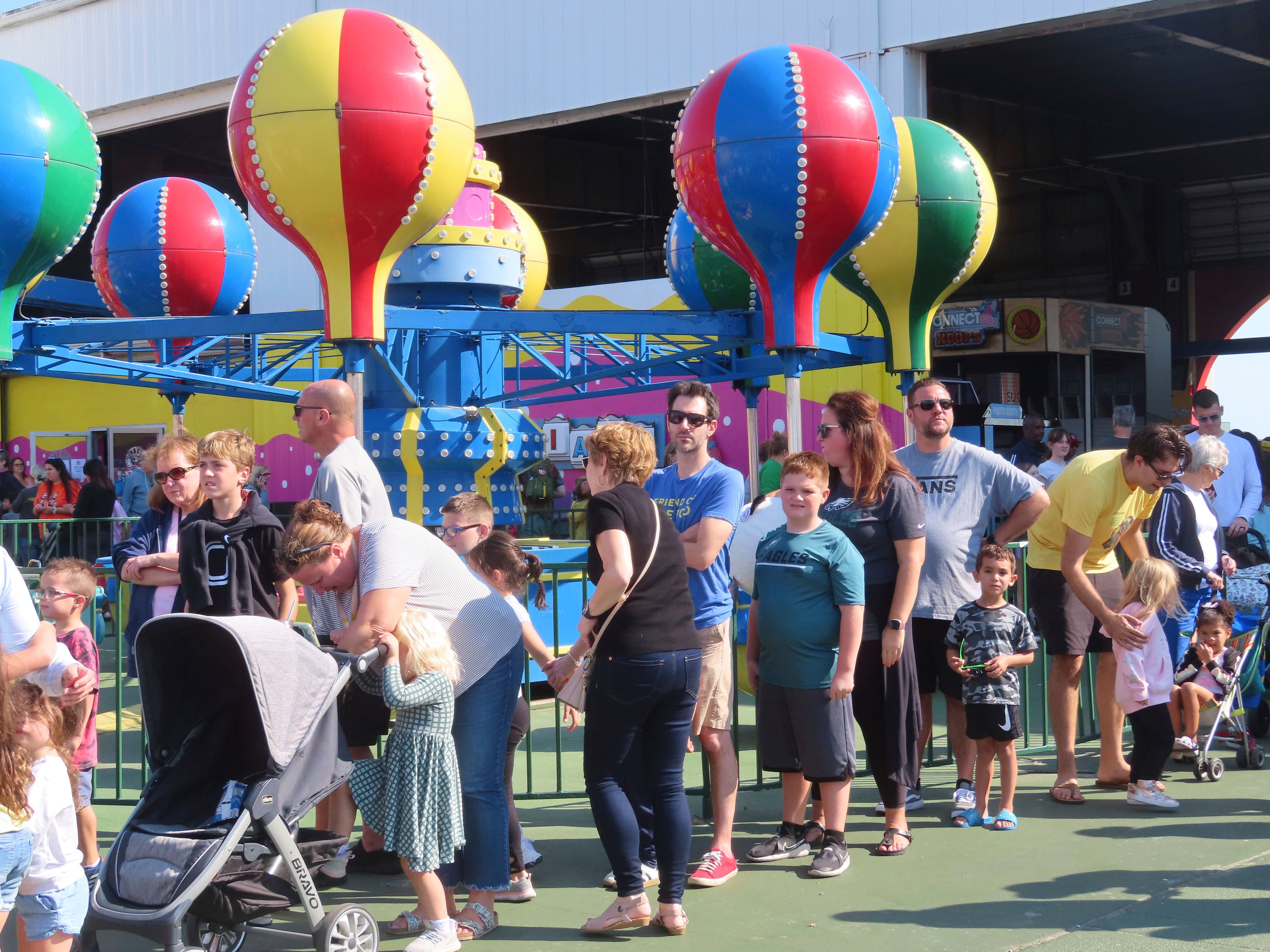 People wait in line to board rides at Gillian's Wonderland, the popular amusement park on the boardwalk in Ocean City, N.J., during its final day of operation before shutting down for good, Sunday, Oct. 13, 2024. (AP Photo/Wayne Parry)