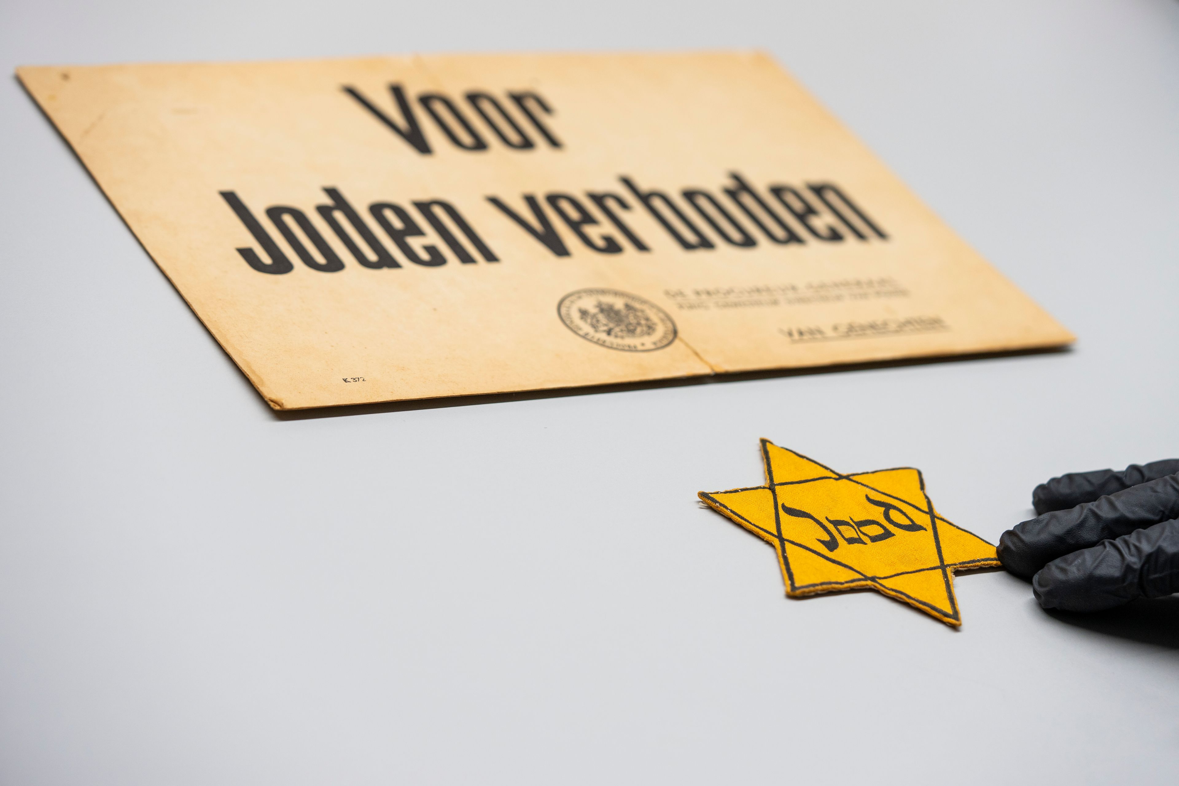 One of the yellow stars Jews were ordered to wear in the occupied Netherlands is displayed next to a sign reading "Forbidden For Jews" at the Anne Frank House in Amsterdam, Netherlands, Friday, Oct. 4, 2024. (AP Photo/Peter Dejong)