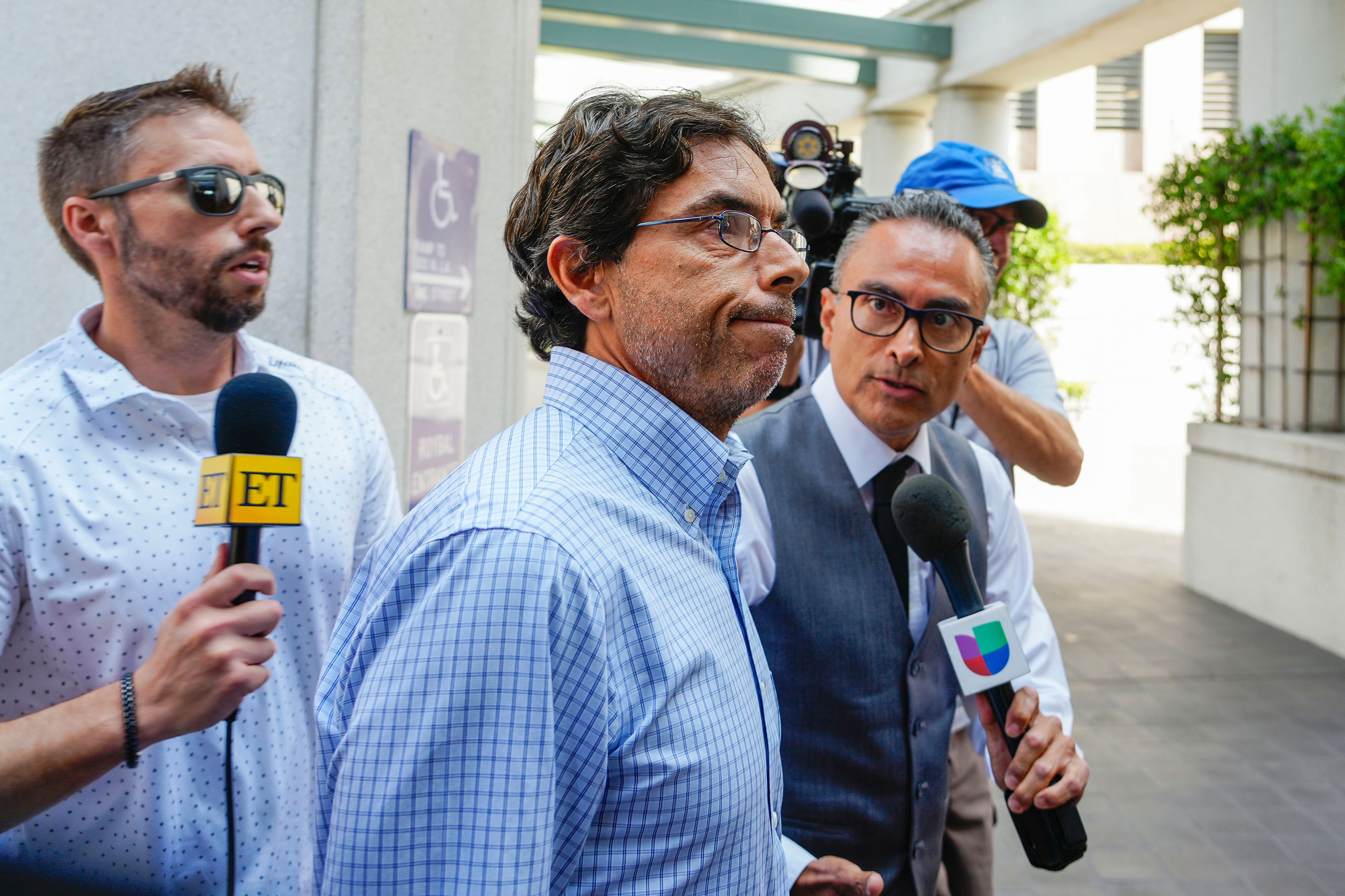 FILE - Dr. Mark Chavez, center, a physician from San Diego, who is charged in connection with actor Matthew Perry's death from an accidental ketamine overdose, arrives at the Roybal Federal Courthouse in Los Angeles, Friday, Aug. 30, 2024. (AP Photo/Damian Dovarganes, File)