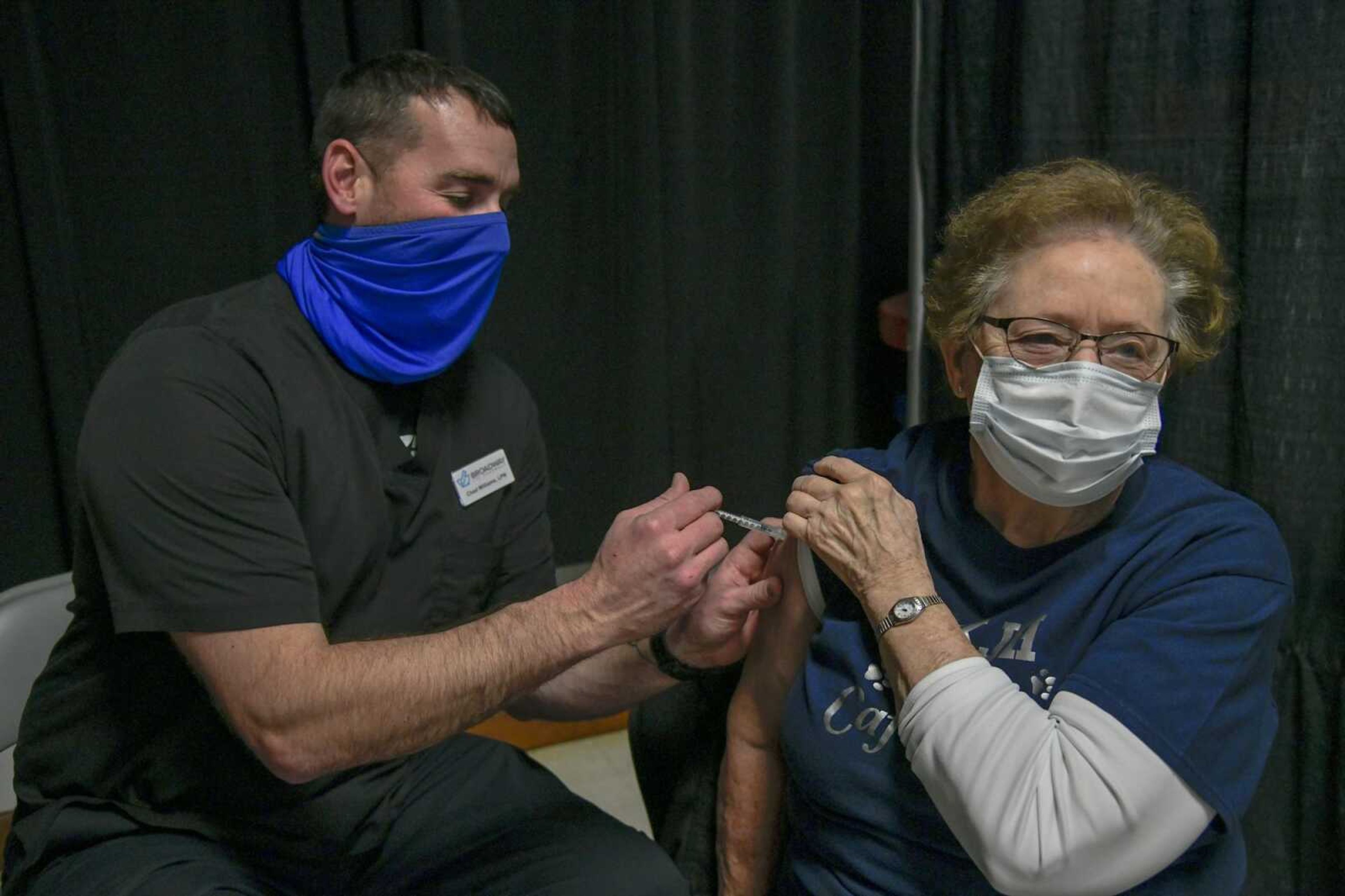 LPN Chad Williams administers a second COVID-19 vaccine dose to Martha Wills through a Broadway Pharmacy vaccination clinic at the 4-H Building in Arena Park on Monday in Cape Girardeau.