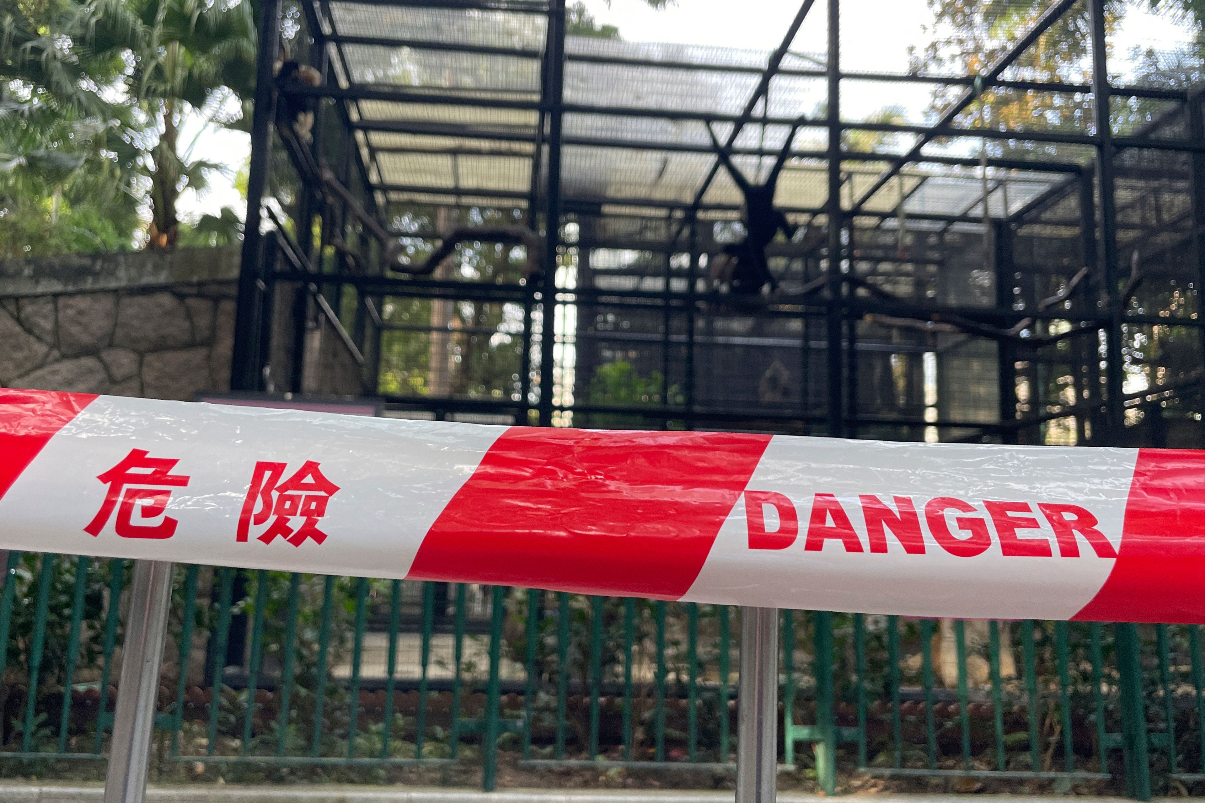 A cordon with the words danger is placed around the enclosures of monkeys after the mysterious deaths of several monkeys at the Hong Kong Zoological and Botanical Gardens in Hong Kong, Tuesday, Oct. 15, 2024. (AP Photo)