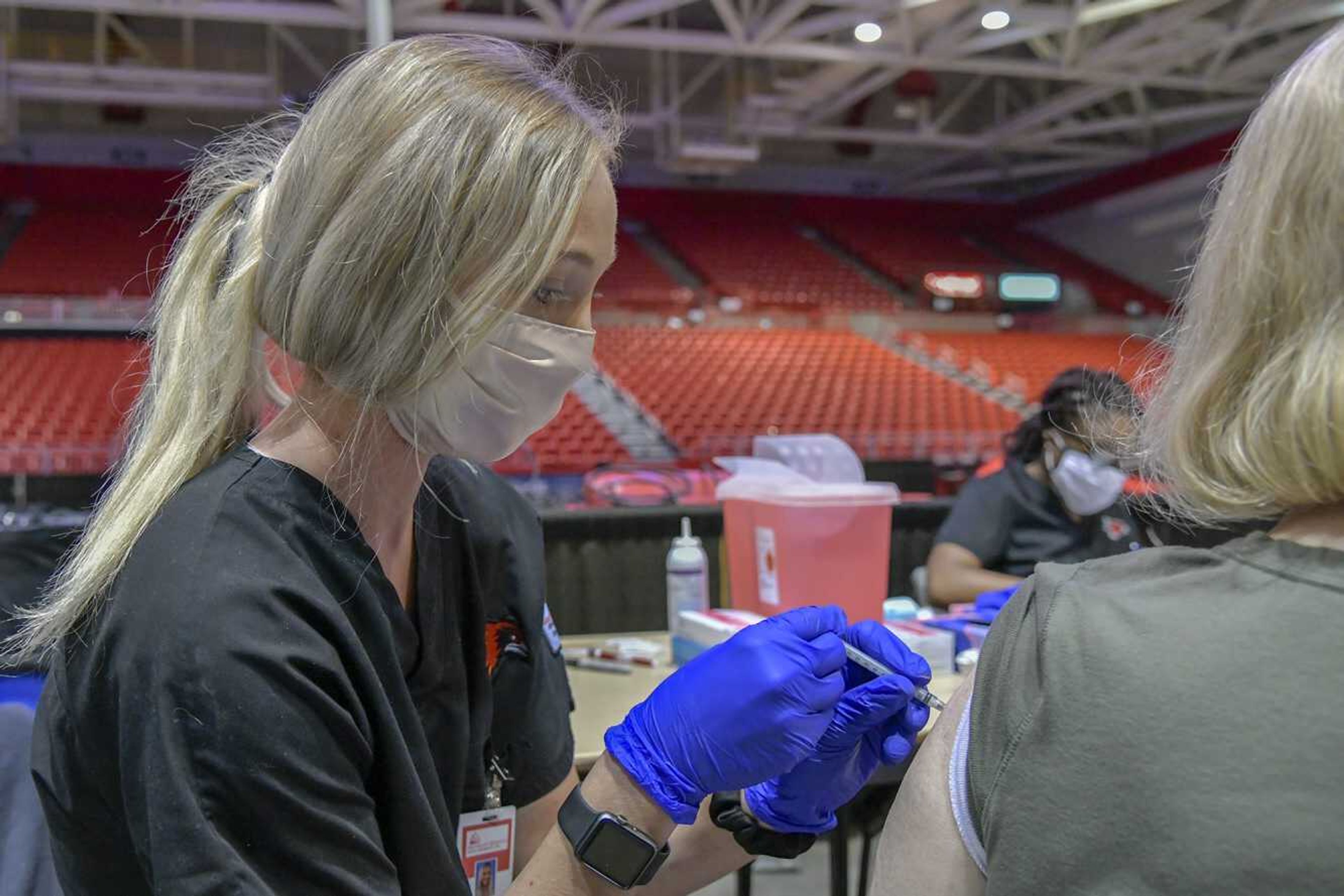 Southeast Missouri State University nursing student Rylie Gant administers a COVID-19 vaccine dose Friday at the Show Me Center in Cape Girardeau.