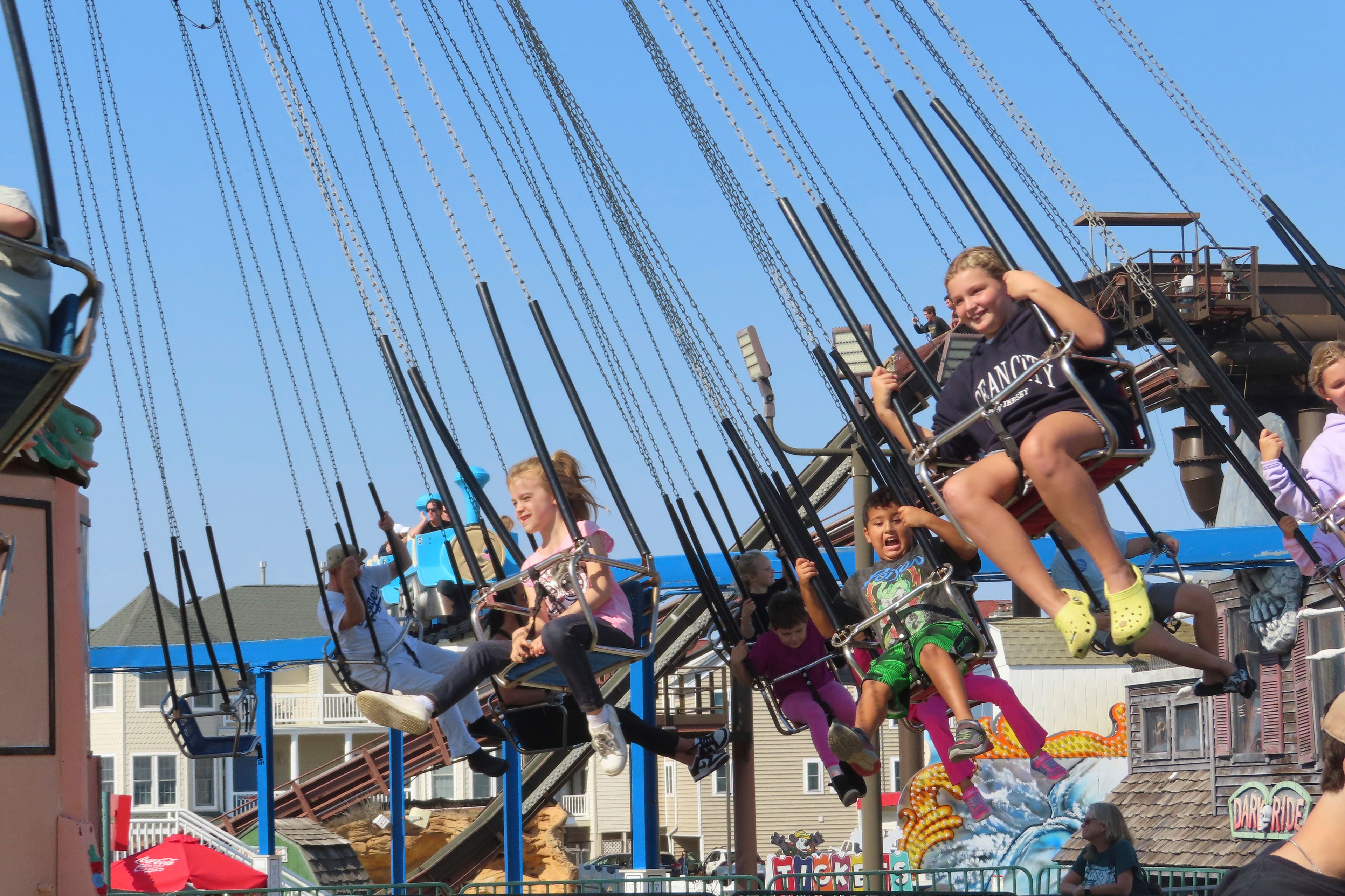 People ride the flying chair attraction at Gillian's Wonderland, the popular amusement park on the boardwalk in Ocean City, N.J., during its final day of operation before shutting down for good, Sunday, Oct. 13, 2024. (AP Photo/Wayne Parry)