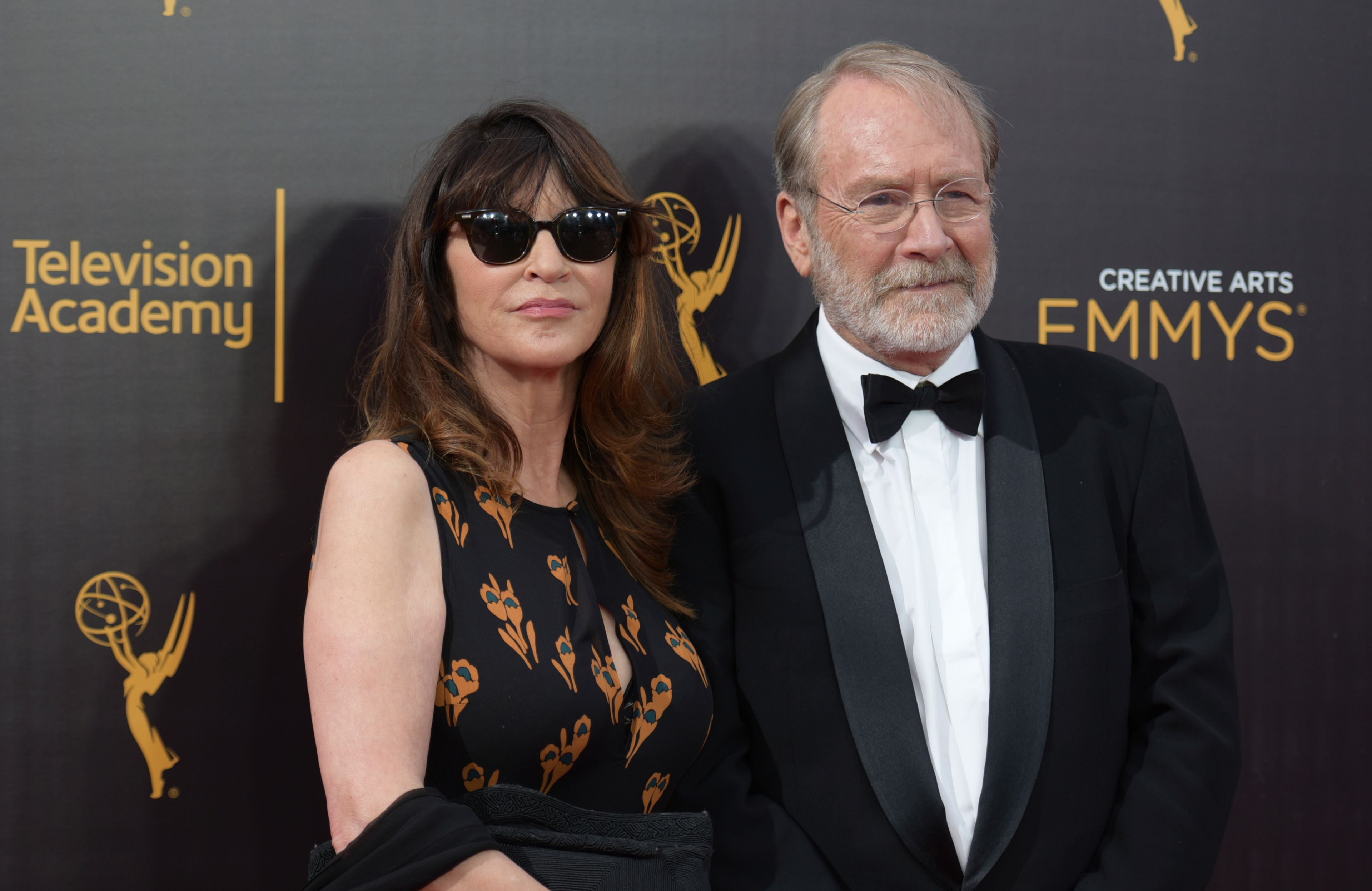 FILE -Wendy Haas, left, and Martin Mull arrive at night one of the Creative Arts Emmy Awards at the Microsoft Theater on Saturday, Sept. 10, 2016, in Los Angeles. Martin Mull, whose droll, esoteric comedy and acting made him a hip sensation in the 1970s and later a beloved guest star on sitcoms including “Roseanne” and “Arrested Development,” has died, his daughter said Friday, June 28, 2024. (Photo by Richard Shotwell/Invision/AP, File)