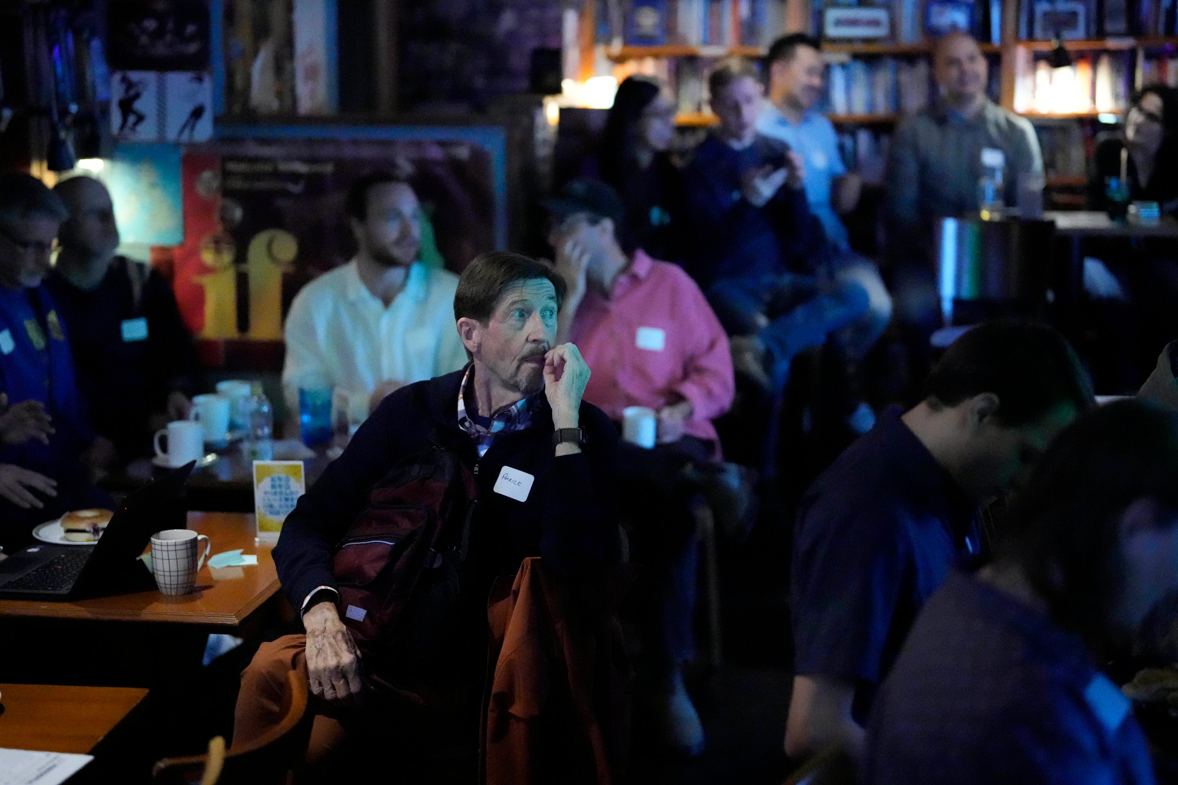 Guests watch the screen showing a live broadcast of the 2024 U.S. Presidential Election results at Good Heavens Bar Wednesday, Nov. 6, 2024, in Tokyo. (AP Photo/Eugene Hoshiko)