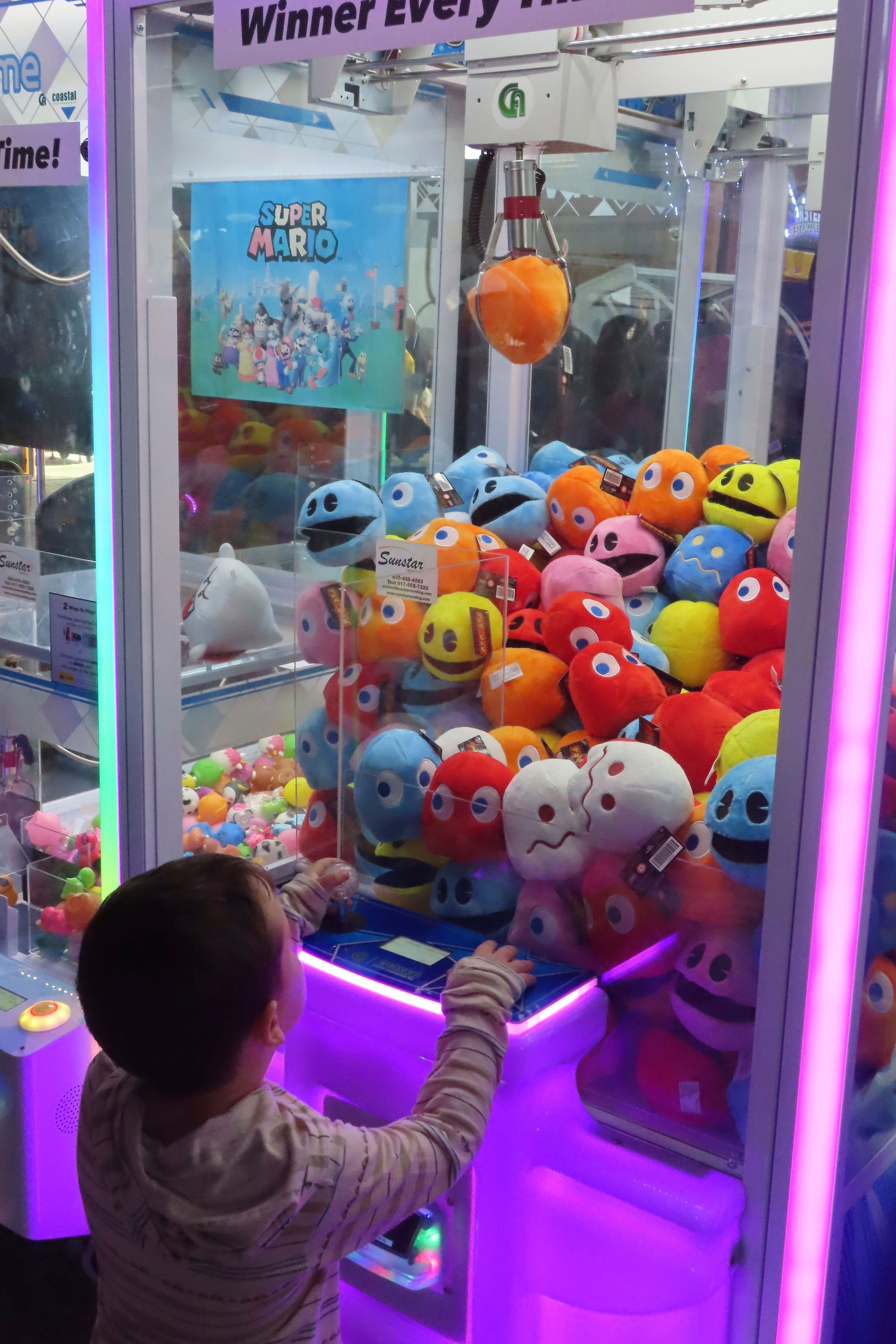 A child wins a prize in an arcade game at Gillian's Wonderland, the popular amusement park on the boardwalk in Ocean City, N.J., during its final day of operation before shutting down for good, Sunday, Oct. 13, 2024. (AP Photo/Wayne Parry)