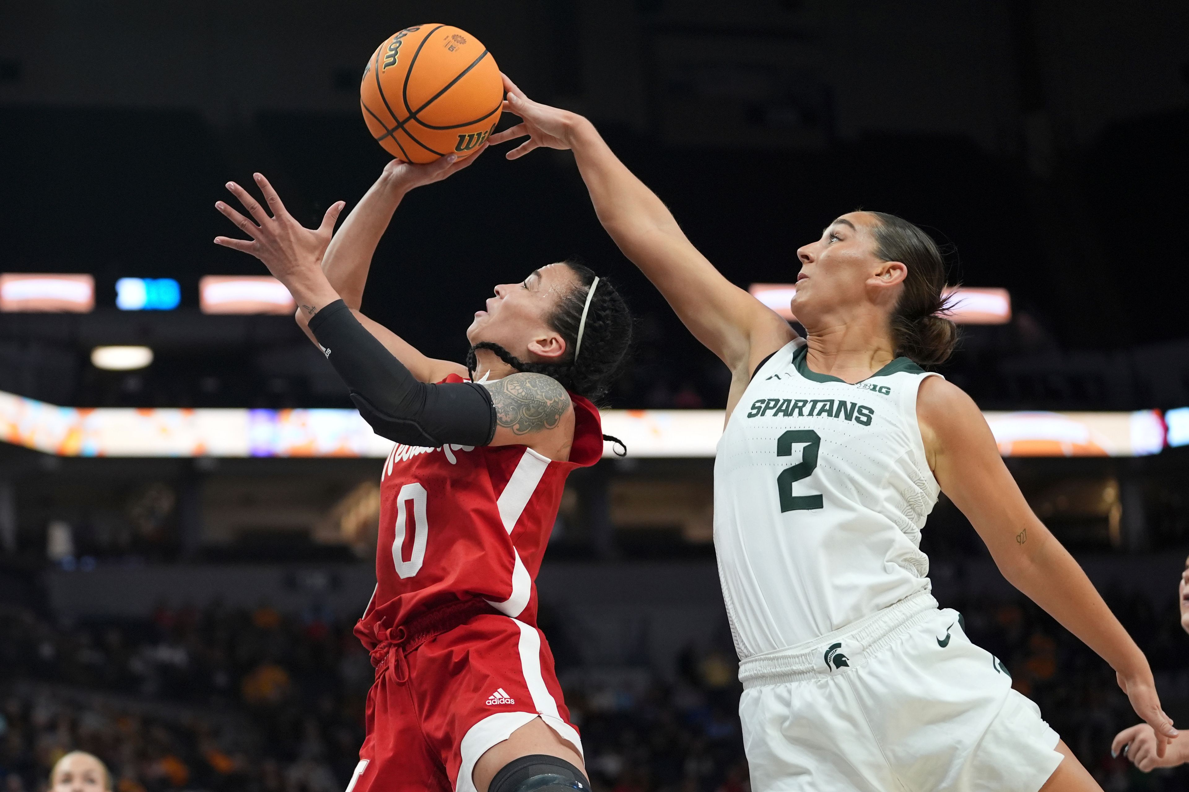 Nebraska guard Darian White (0) shoots as Michigan State guard Abbey Kimball (2) defends during the first half of an NCAA college basketball quarterfinal game at the Big Ten women's tournament Friday, March 8, 2024, in Minneapolis. (AP Photo/Abbie Parr)