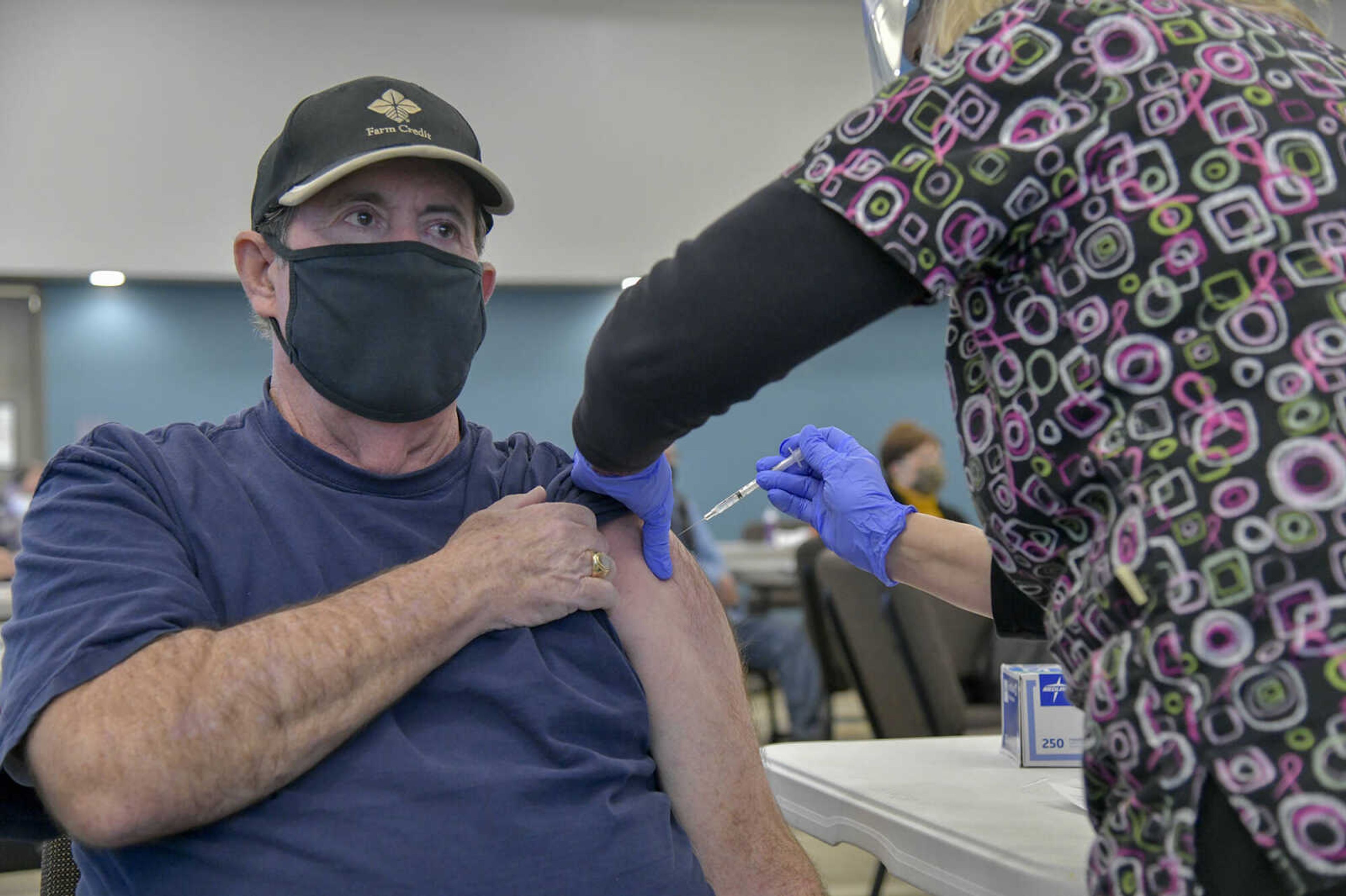 From left, Thomas Little receives a dose of a COVID-19 vaccine from nurse Joyce Clark during a SoutheastHEALTH vaccination clinic at Jackson Civic Center on  Jan. 20.