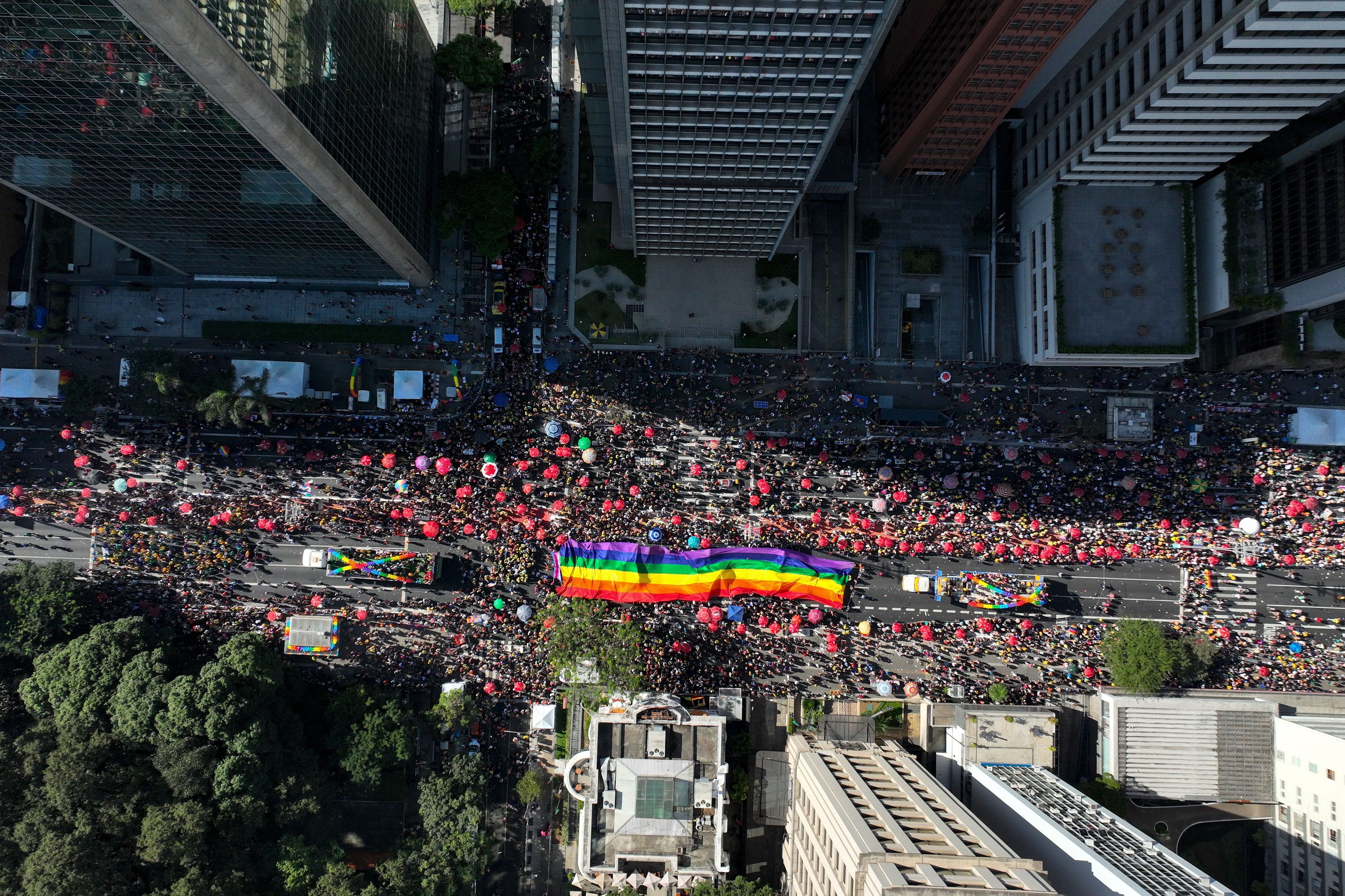 Participants carry a rainbow banner as thousands march in the annual Pride Parade in Sao Paulo, Sunday, June 2, 2024. (AP Photo/Andre Penner)