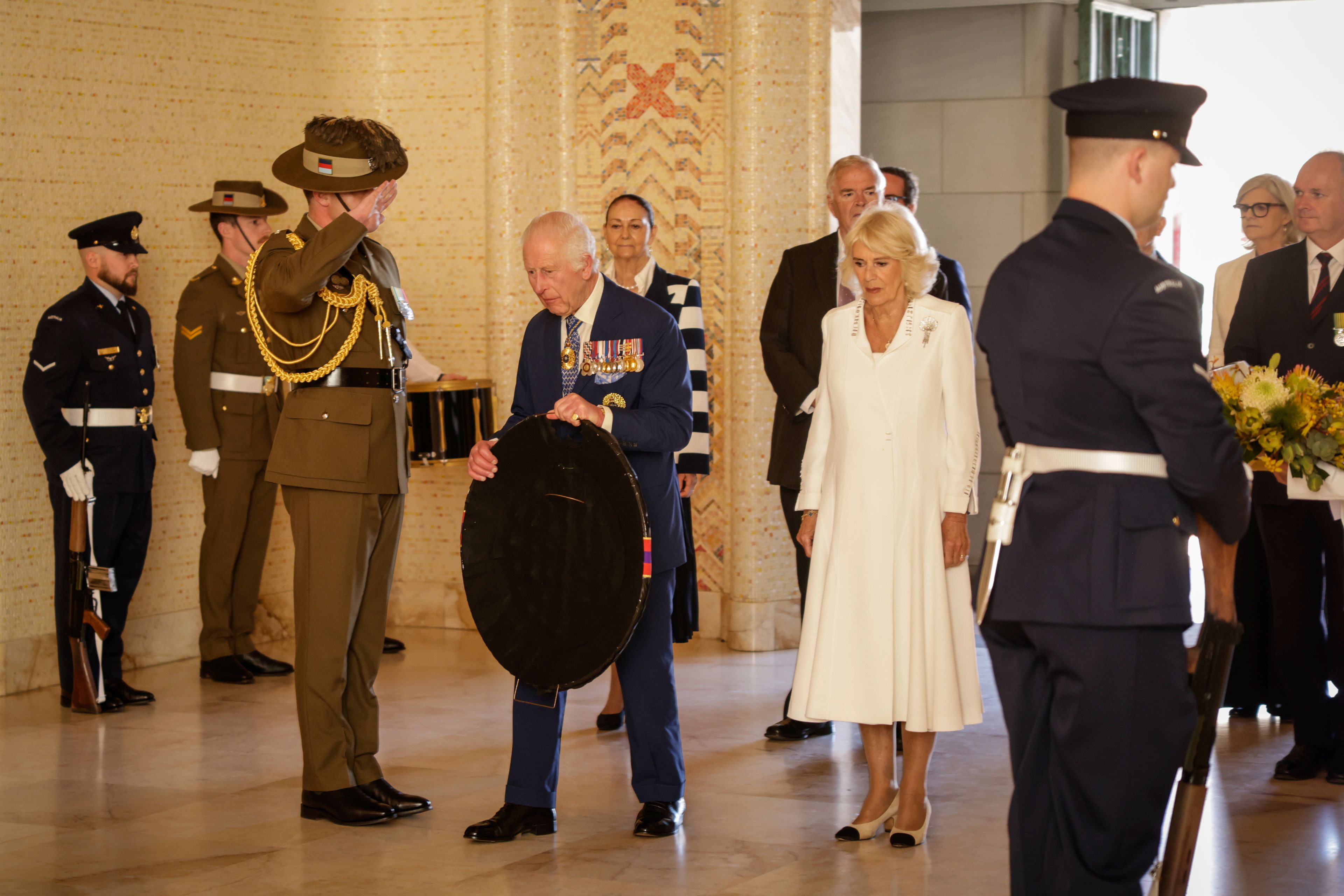 Britain's King Charles III, center left, and Queen Camilla, center right, arrive to lay a wreath at the Australian War Memorial in Canberra, Australia, Monday, Oct. 21, 2024. (Brook Mitchell/Pool Photo via AP)