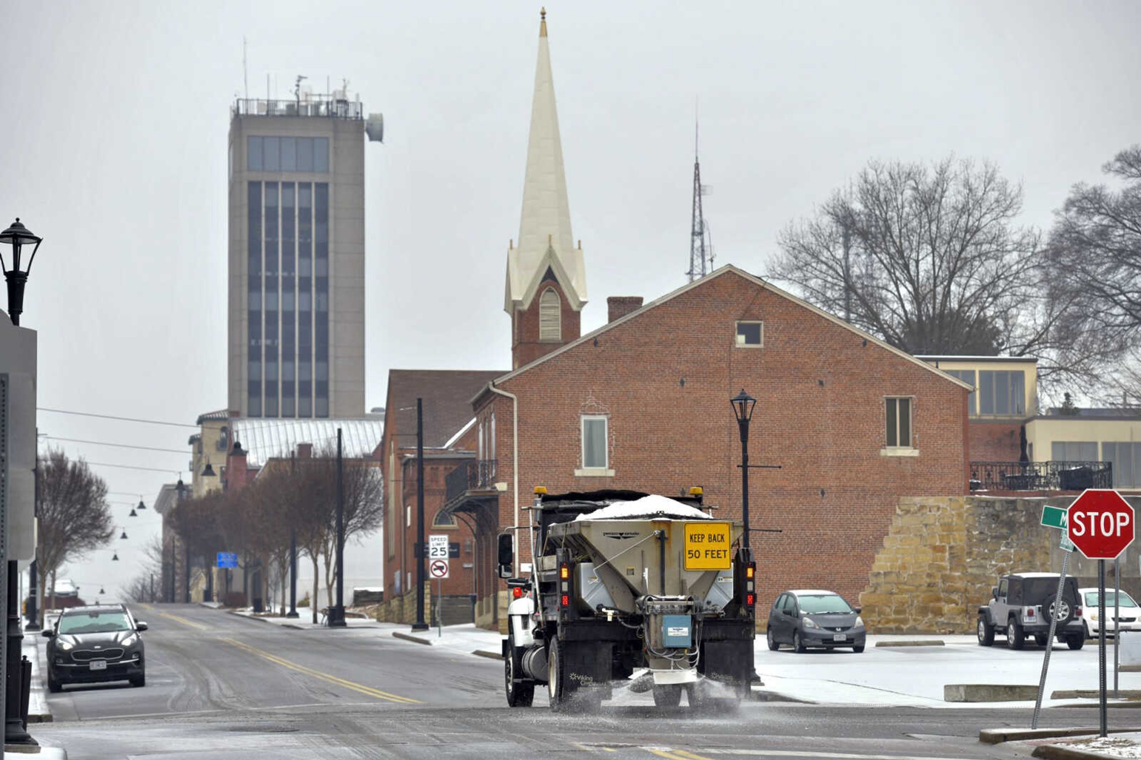 A City of Cape Girardeau Public Works truck dispenses salt onto Broadway on Wednesday in Cape Girardeau during a winter storm with ice accumulations. City crews have been working on the streets since Wednesday as temperatures are below freezing and weather forcasts are calling for even lower temperatures this weekend along with snow Monday.