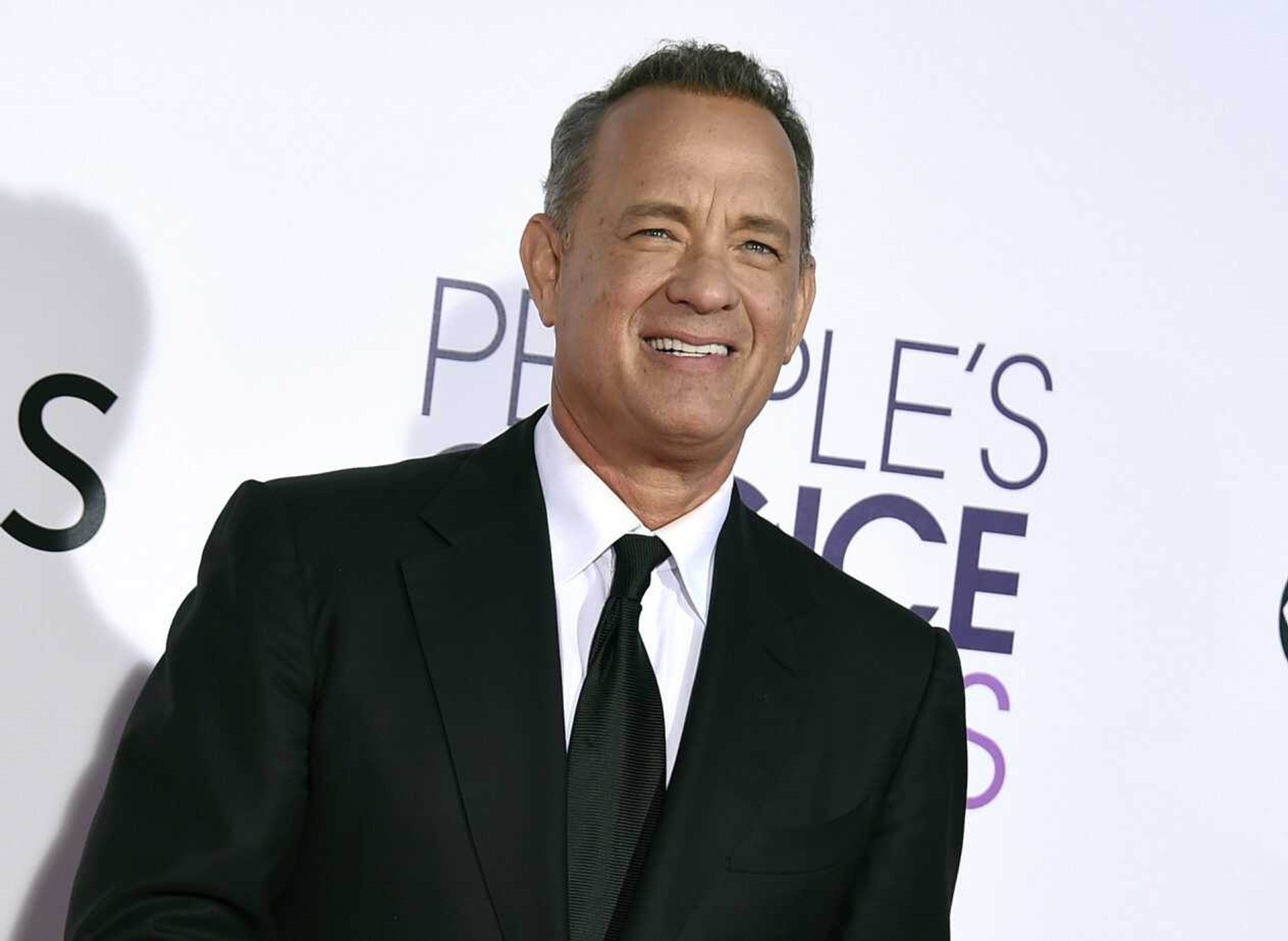 In this Jan. 18, 2017, file photo, Tom Hanks arrives at the People's Choice Awards at the Microsoft Theater in Los Angeles. Hanks will host a 90-minute primetime TV special celebrating the inauguration of Joe Biden as president of the United States.