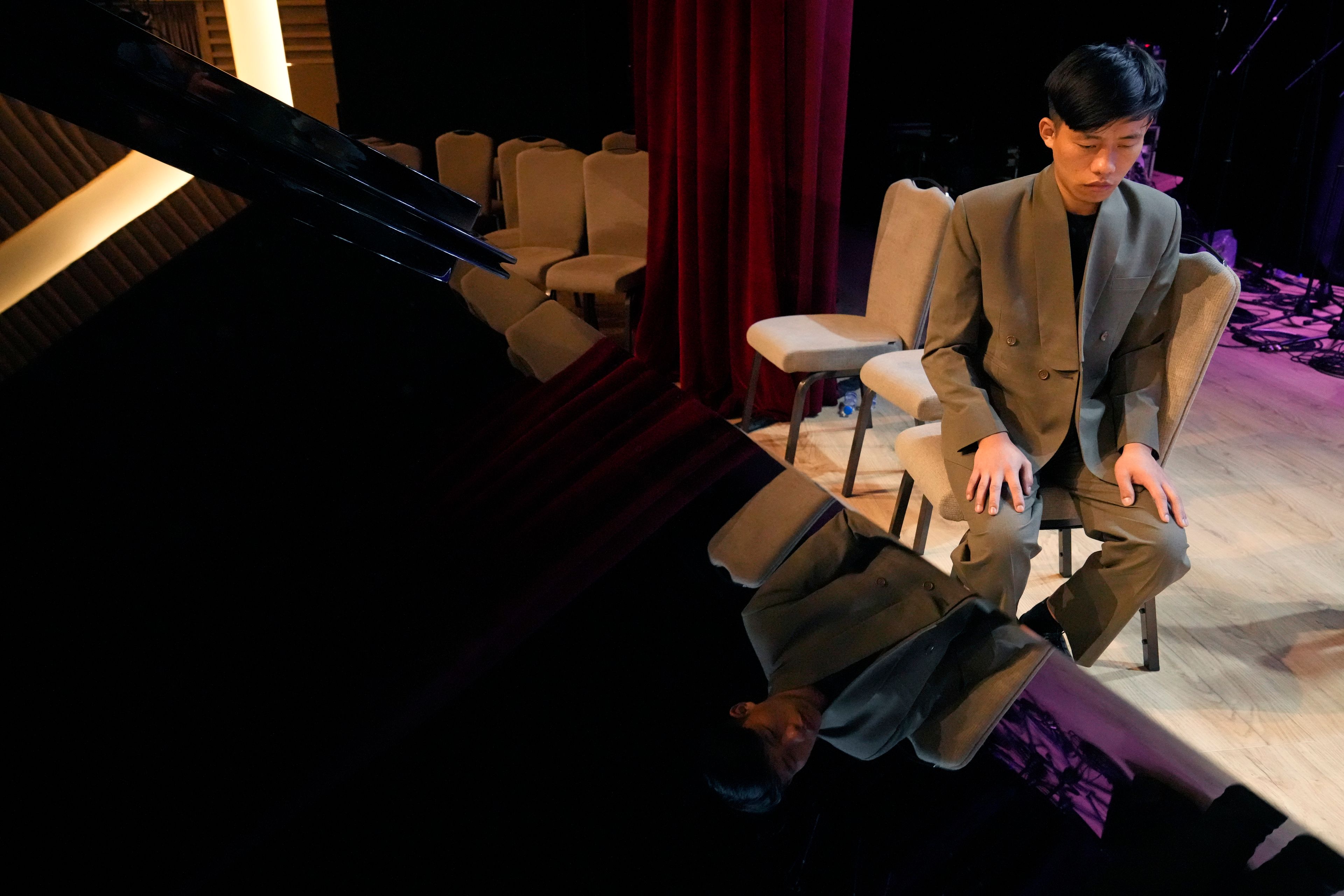 Takosangba Pongen, 27, a blind pianist, waits for his turn to rehearse during the two-day Brillante Piano Festival in Bengaluru, India, Sunday, Sept. 29, 2024. (AP Photo/Aijaz Rahi)