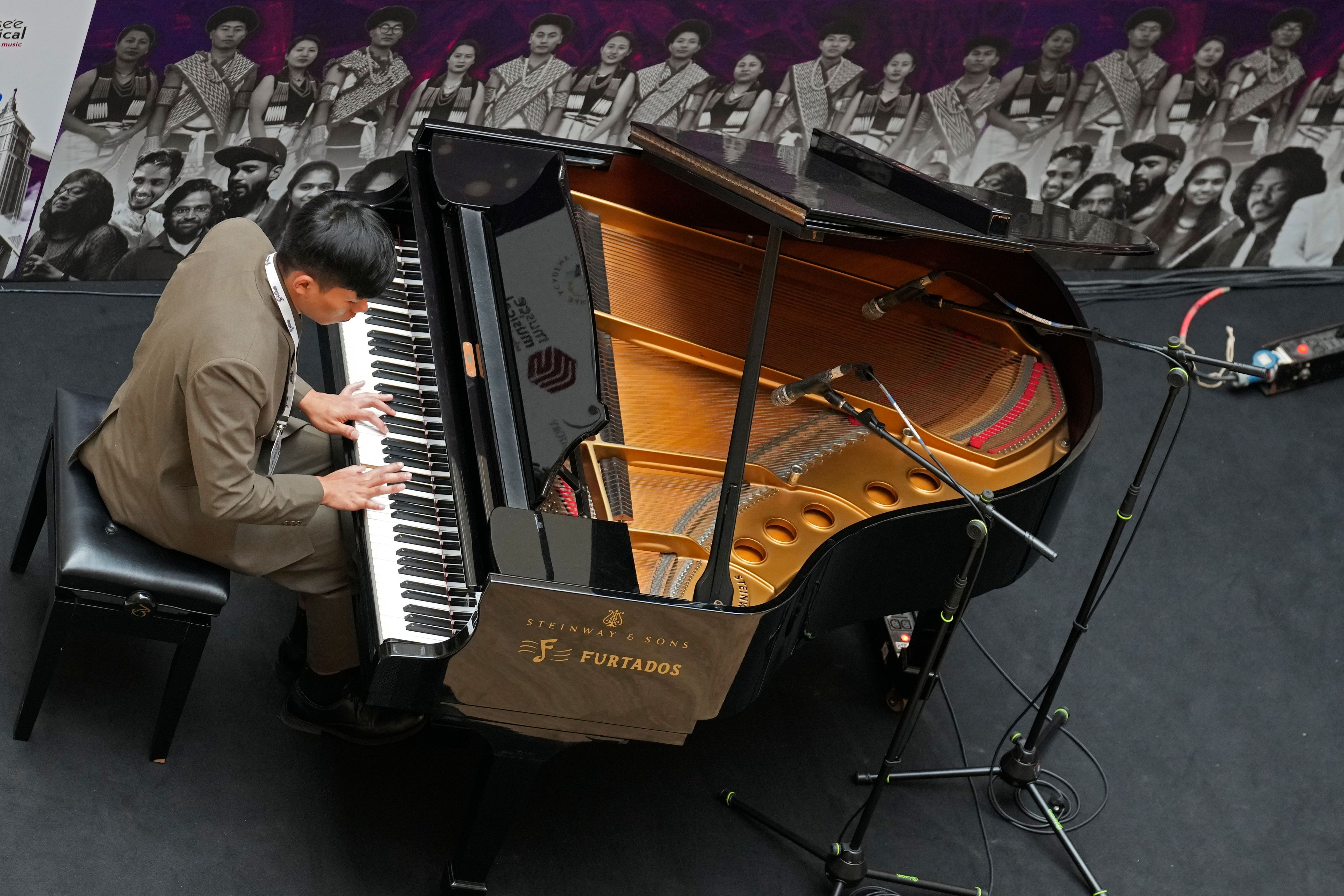 Takosangba Pongen, 27, a blind pianist, performs at a shopping mall during the two-day Brillante Piano Festival in Bengaluru, India, Sunday, Sept. 29, 2024. (AP Photo/Aijaz Rahi)