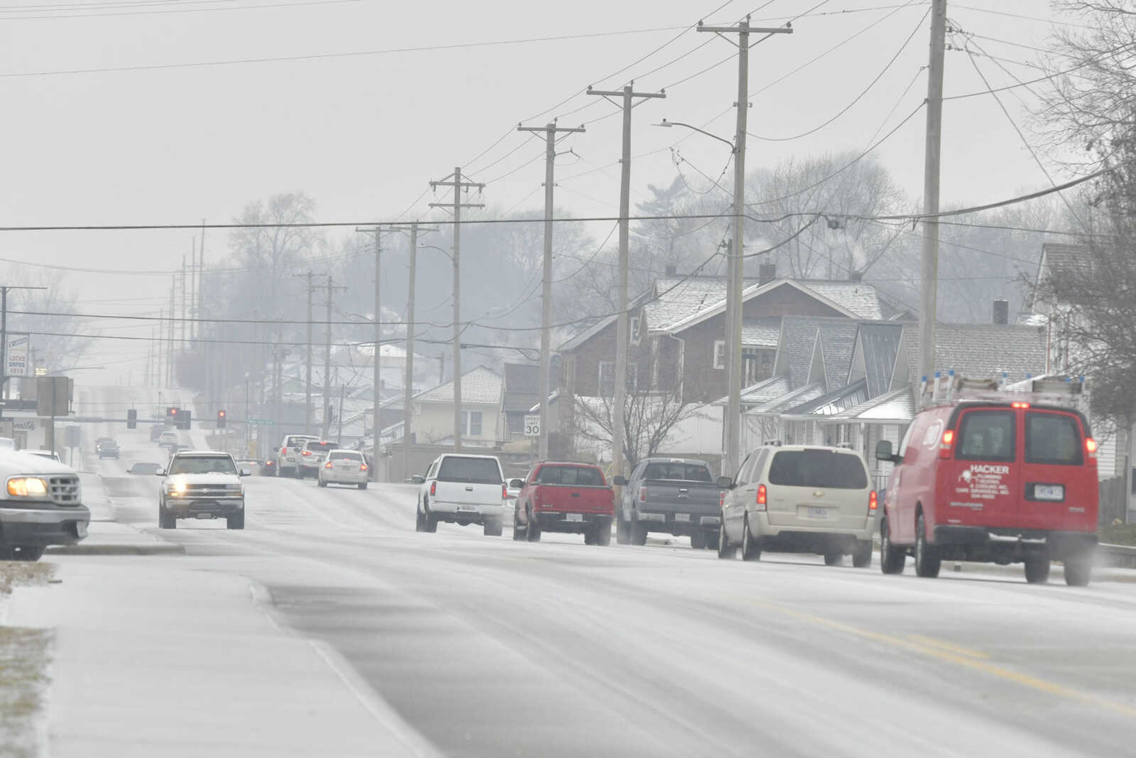 Cars drive along Independence Street during a winter storm with significant ice accumulations in Cape Girardeau on Wednesday, Feb. 10, 2021. 