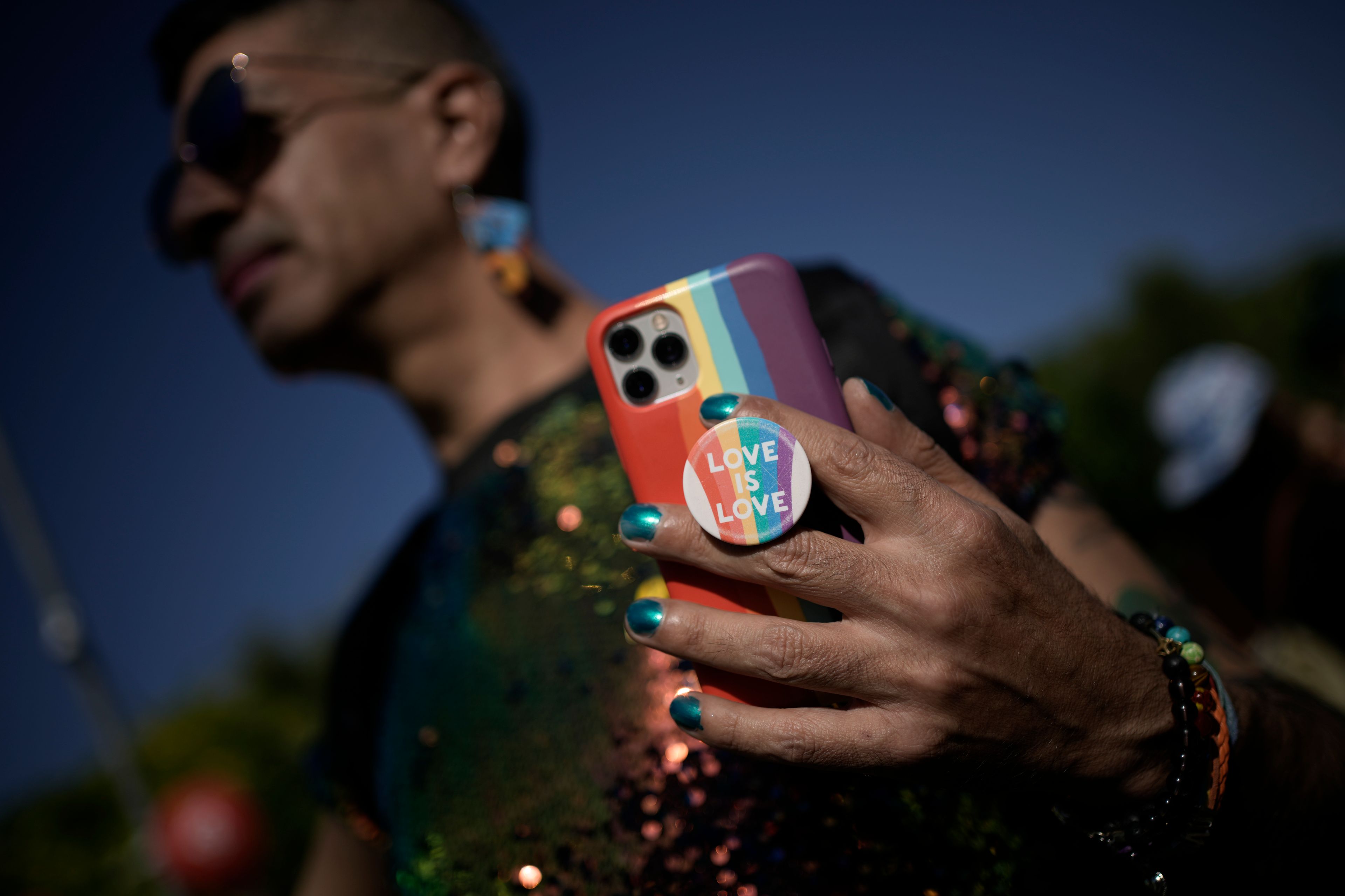A person shows his phone in the annual Pride parade in Jerusalem, Thursday, May 30, 2024.(AP Photo/Leo Correa)