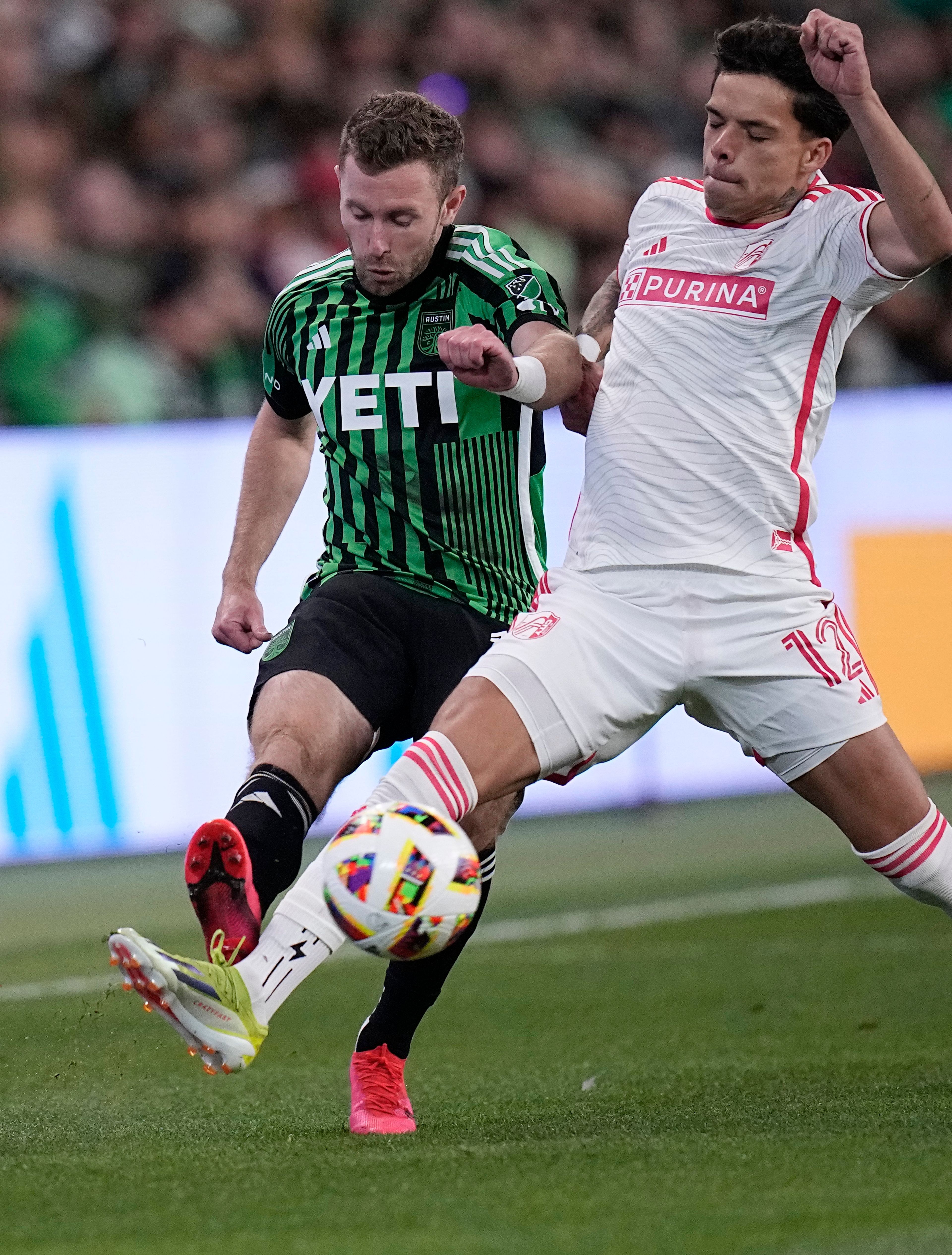 Austin FC forward Jon Gallagher, left, and St. Louis City midfielder Celio Pompeu (12) reach for the ball during the first half of an MLS soccer match Saturday, March 9, 2024, in Austin, Texas. (AP Photo/Eric Gay)