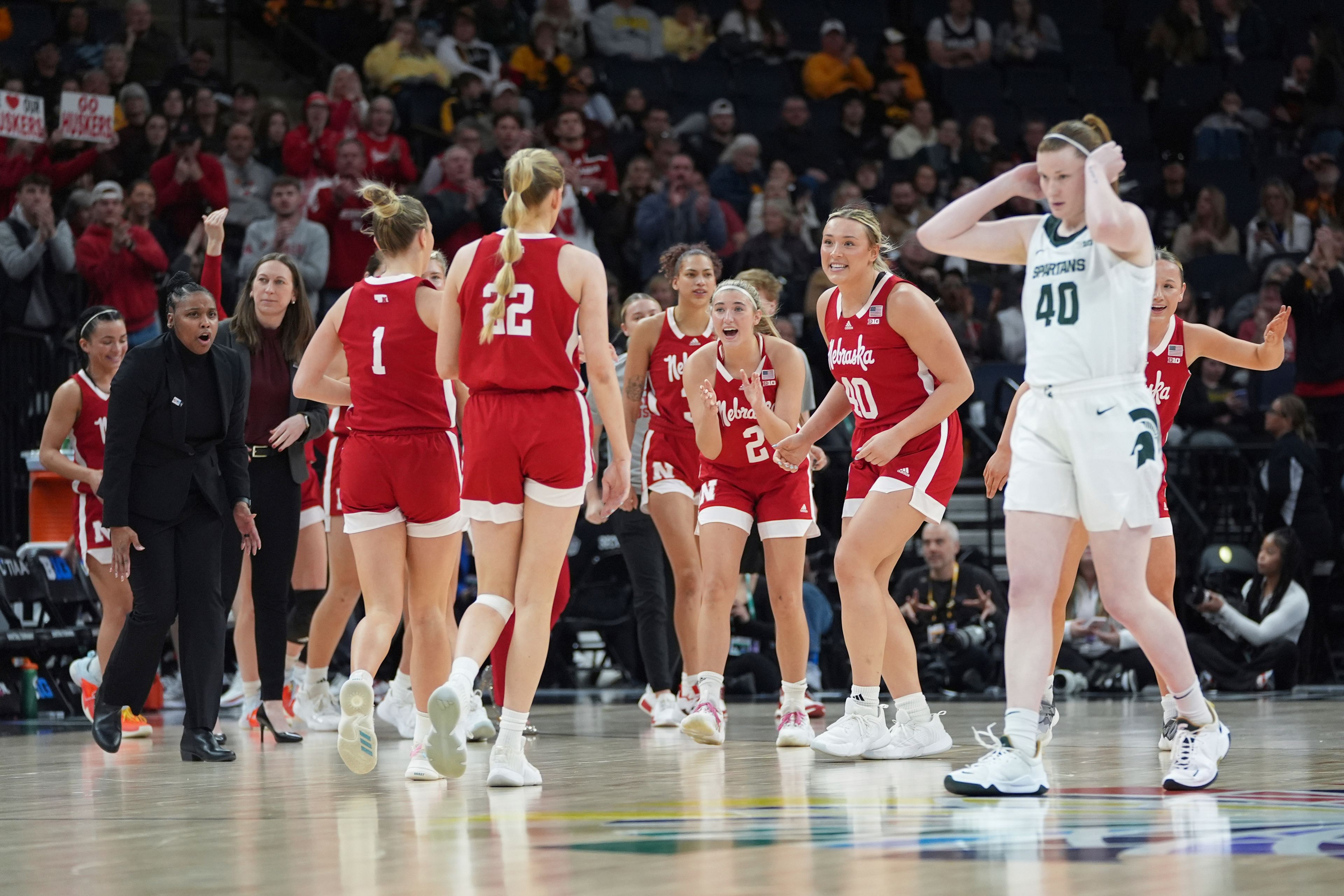 Nebraska players celebrate during the first half of an NCAA college basketball quarterfinal game against Michigan State at the Big Ten women's tournament Friday, March 8, 2024, in Minneapolis. (AP Photo/Abbie Parr)