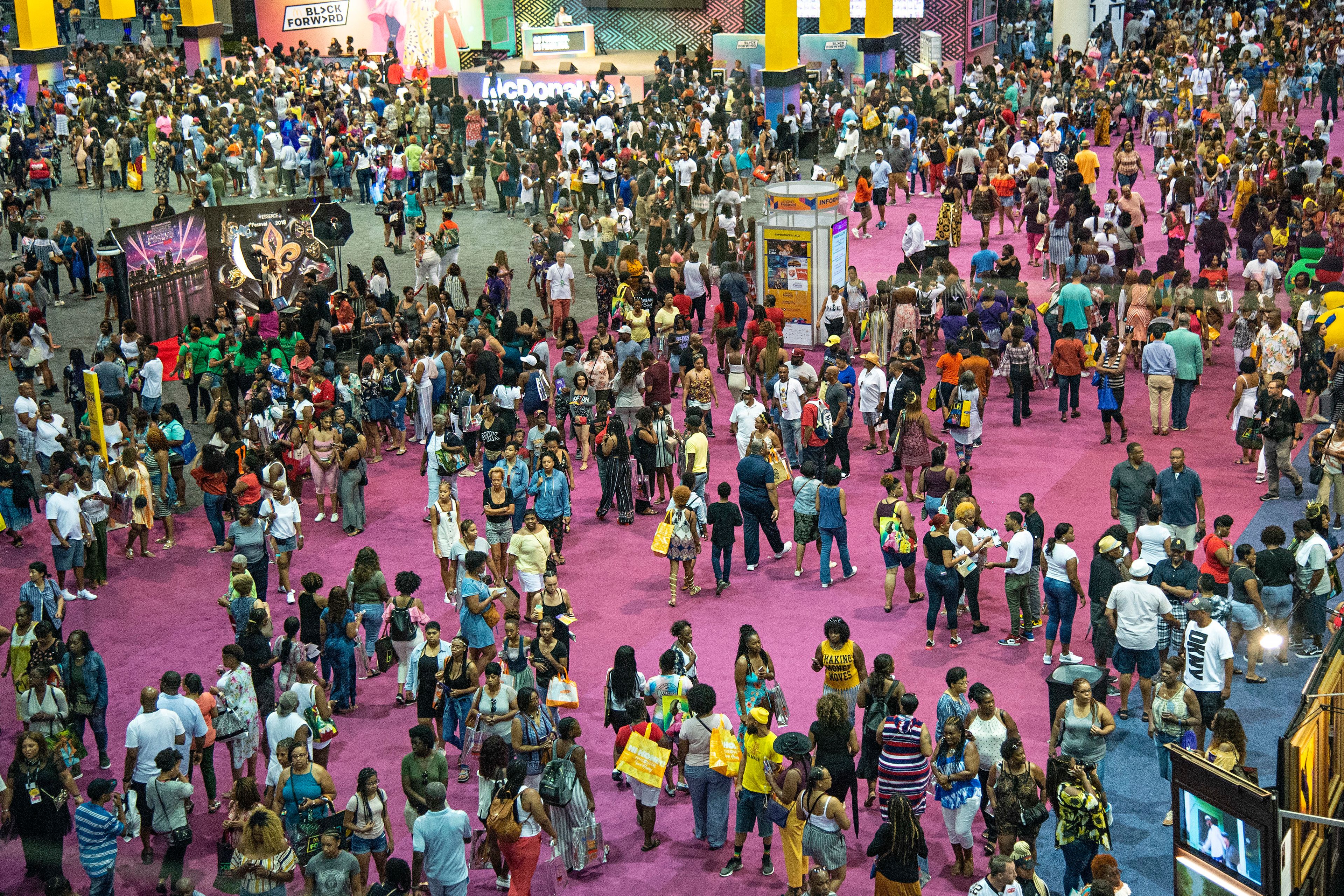 FILE - Attendees walk around the 2018 Essence Festival at the Ernest N. Morial Convention Center, July 6, 2018, in New Orleans. New Orleans officially opened its arms in welcome Thursday, July 4, 2024, to the thousands of people descending on the Big Easy for the 30th annual celebration of the Essence Festival of Culture. (Photo by Amy Harris/Invision/AP, File)