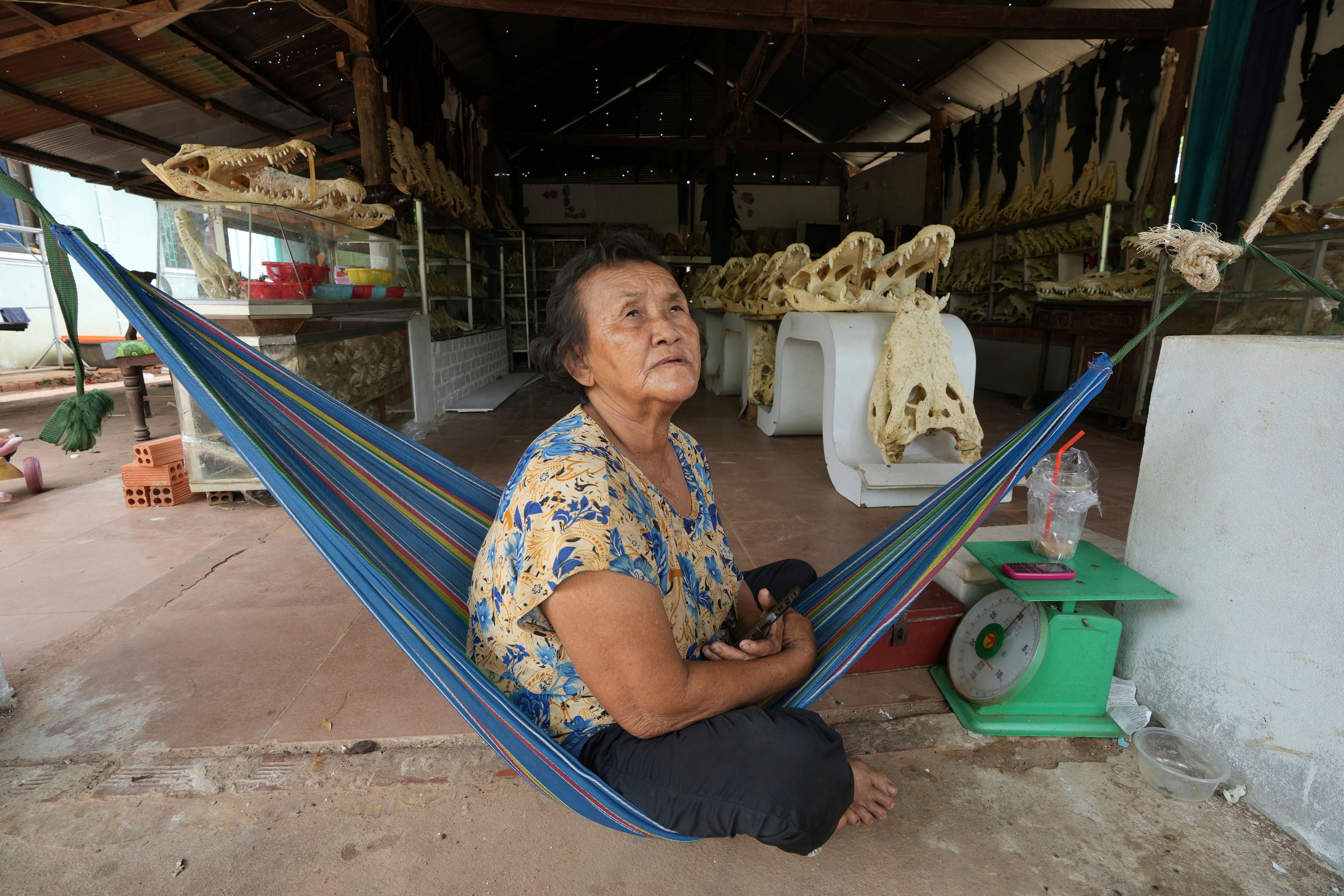 Crocodile farmer Ry Lean, 73, speaks with The Associated Press at her home in Siem Reap province, Cambodia, on Aug. 2, 2024. (AP Photo/Heng Sinith)