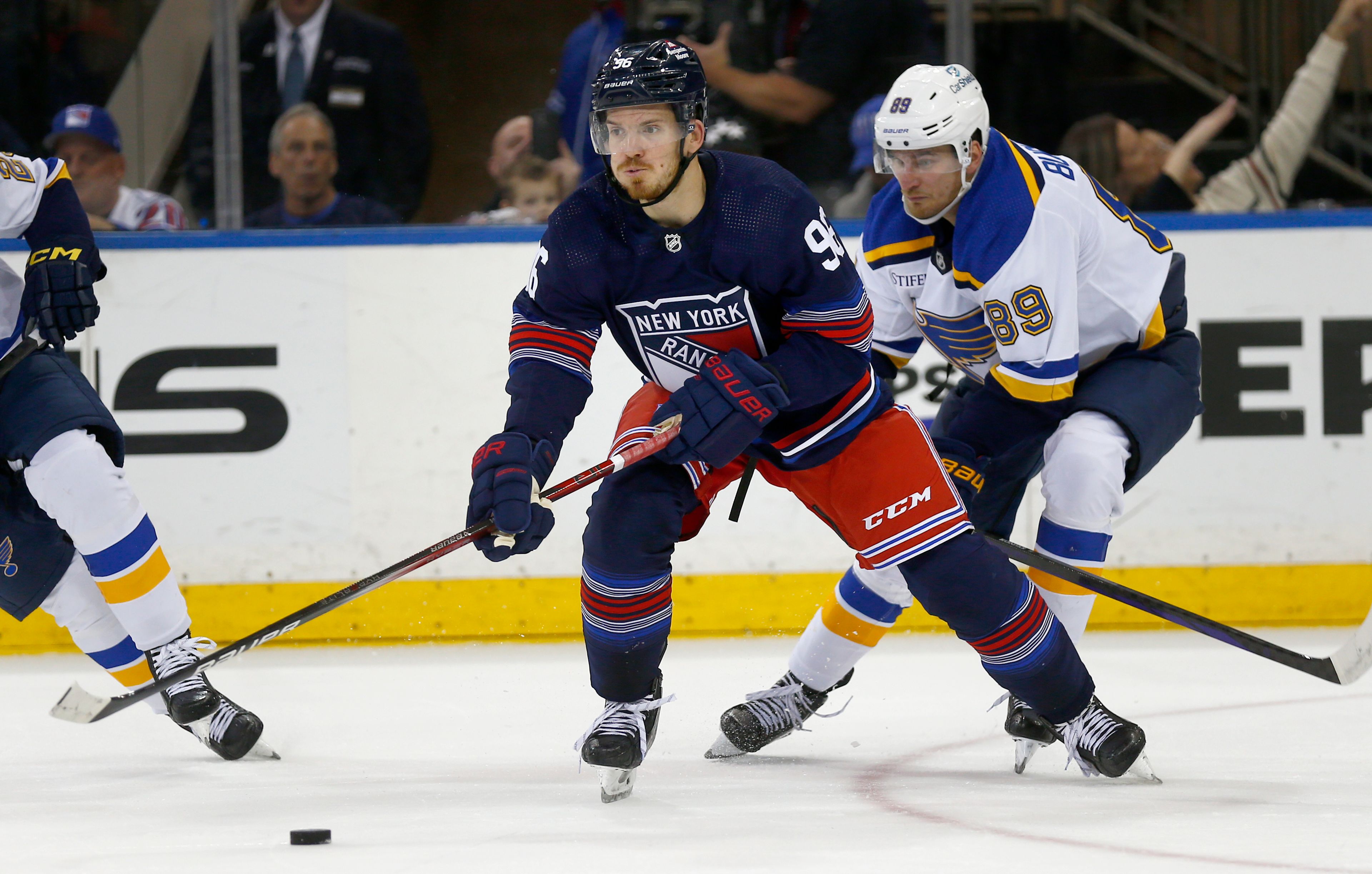 New York Rangers center Jack Roslovic (96) controls the puck in front of St. Louis Blues forward Pavel Buchnevich (89) during the second period of an NHL hockey game Saturday, March 9, 2024, in New York. (AP Photo/John Munson)